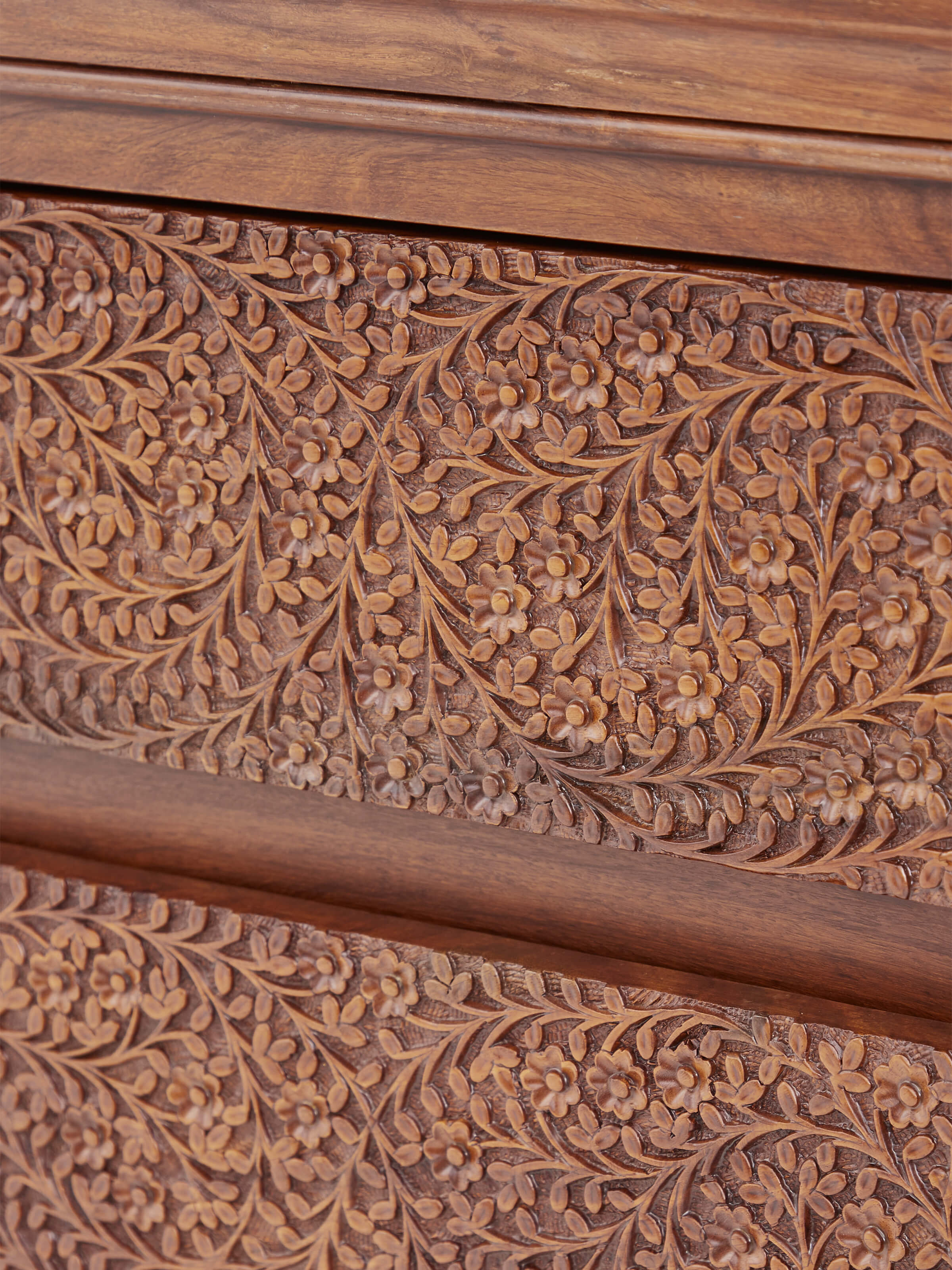 Close-up view of Carved Sheesham Chest of Drawers highlighting the detailed craftsmanship and wood finish.