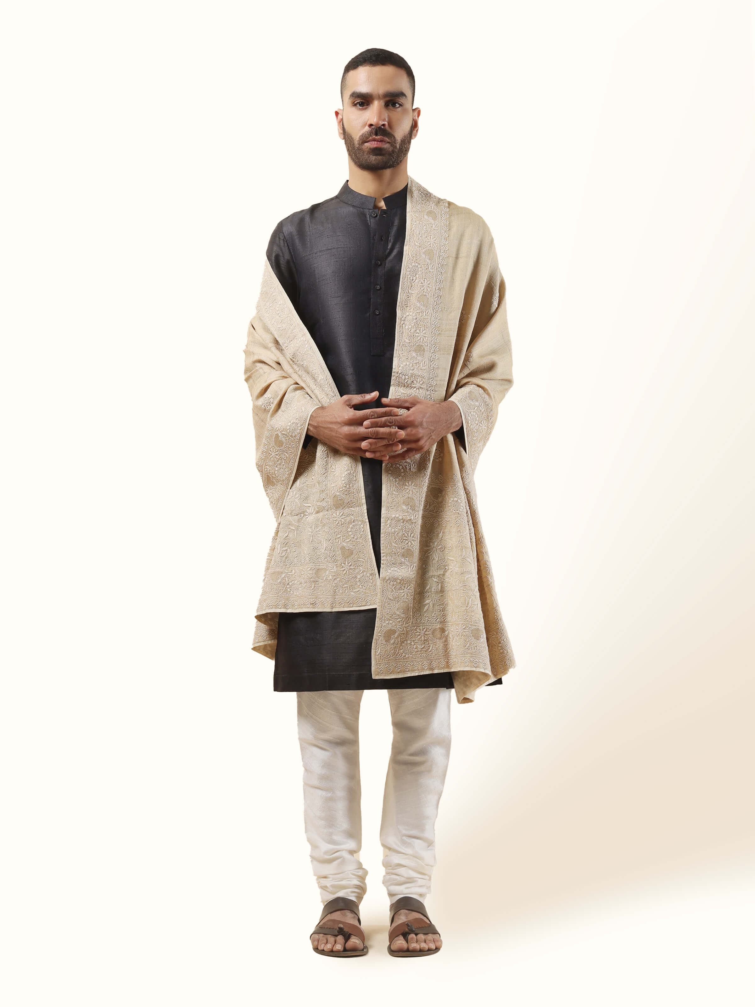 Front view of the beige Tussar silk shawl, intricately hand-embroidered with Chikankari detailing—an elegant layering piece for any occasion.