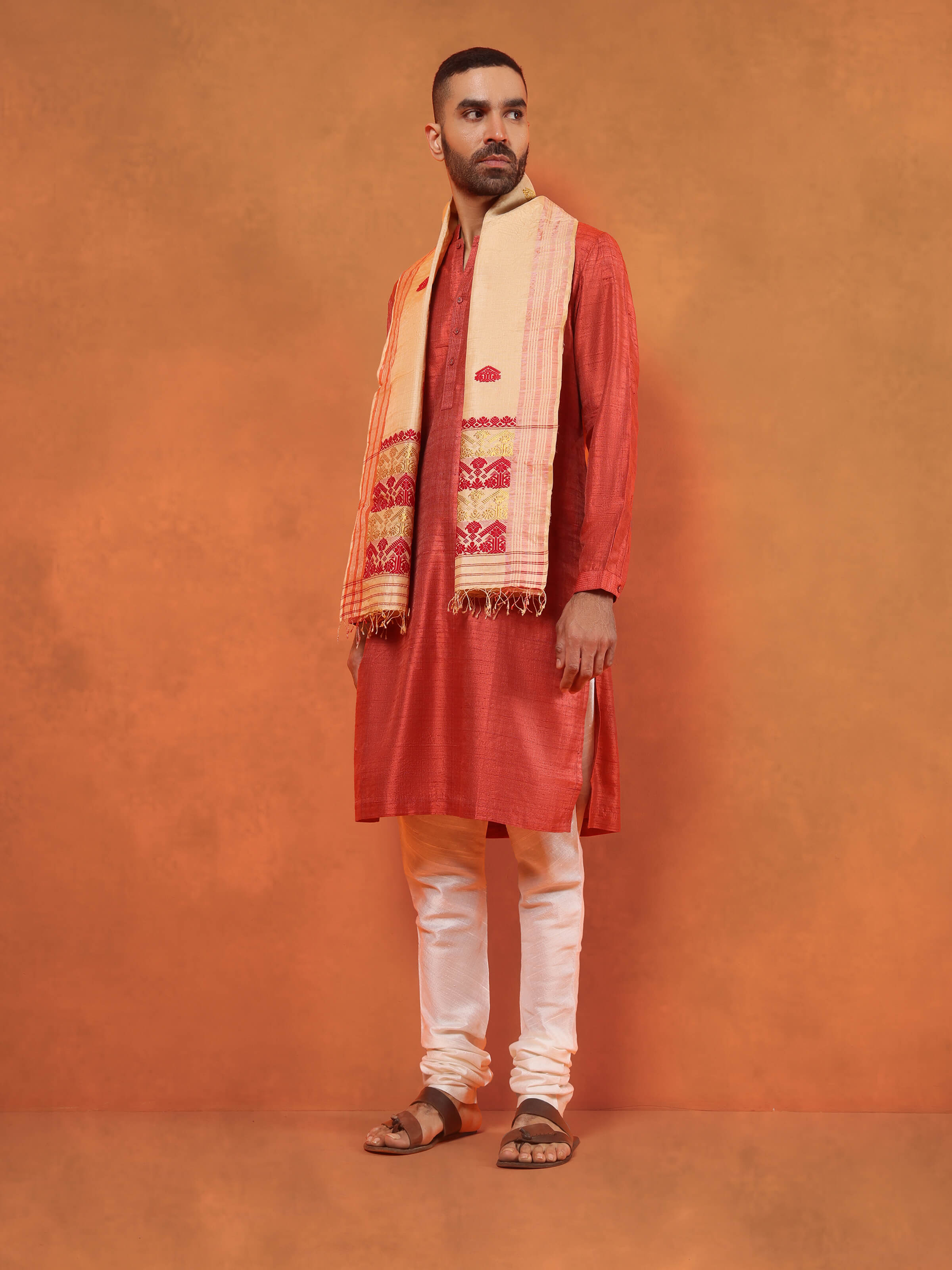 Lifestyle view of peach tussar silk stole draped elegantly over ethnic wear