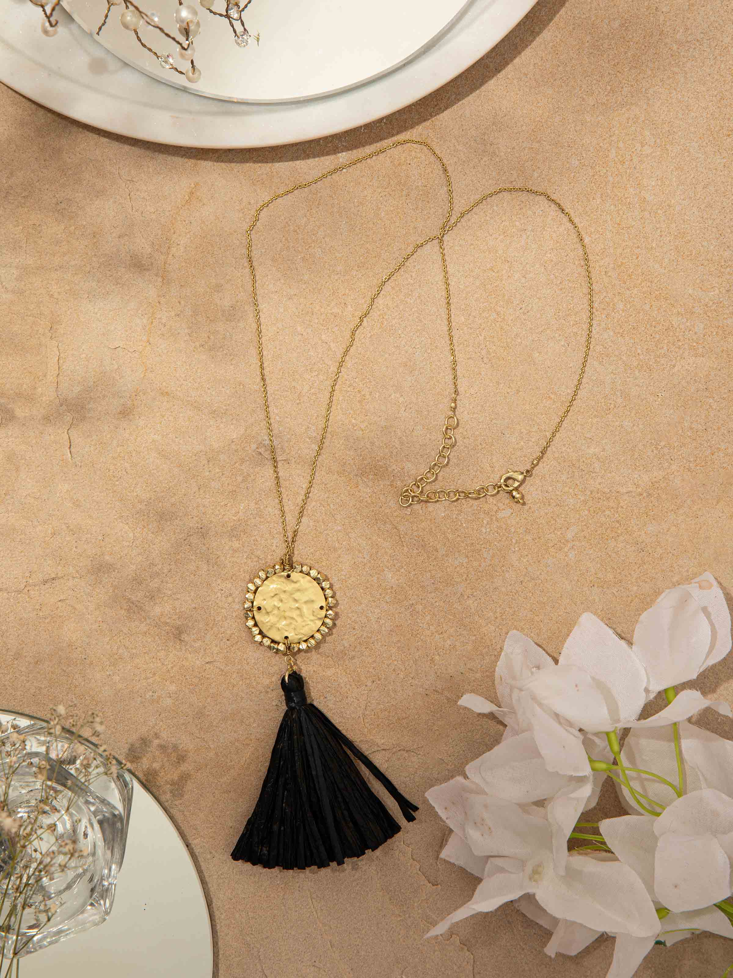 Top view of Raffia fibre long necklace displaying intricate patterns