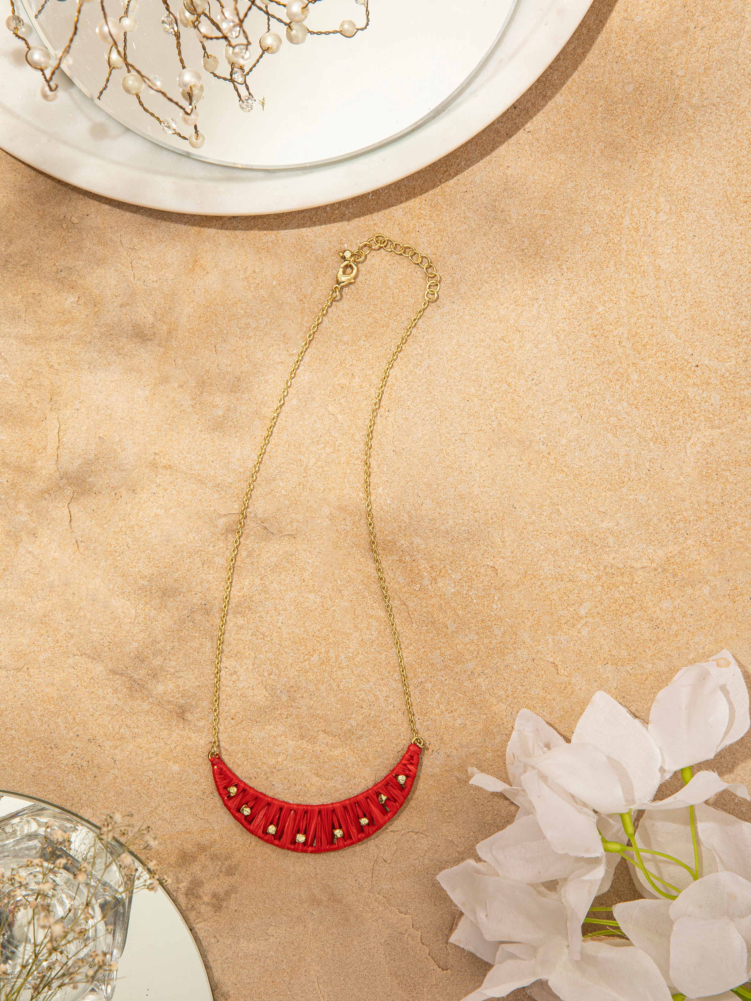 Side view of raffia fibre long necklace emphasizing its unique texture and design.