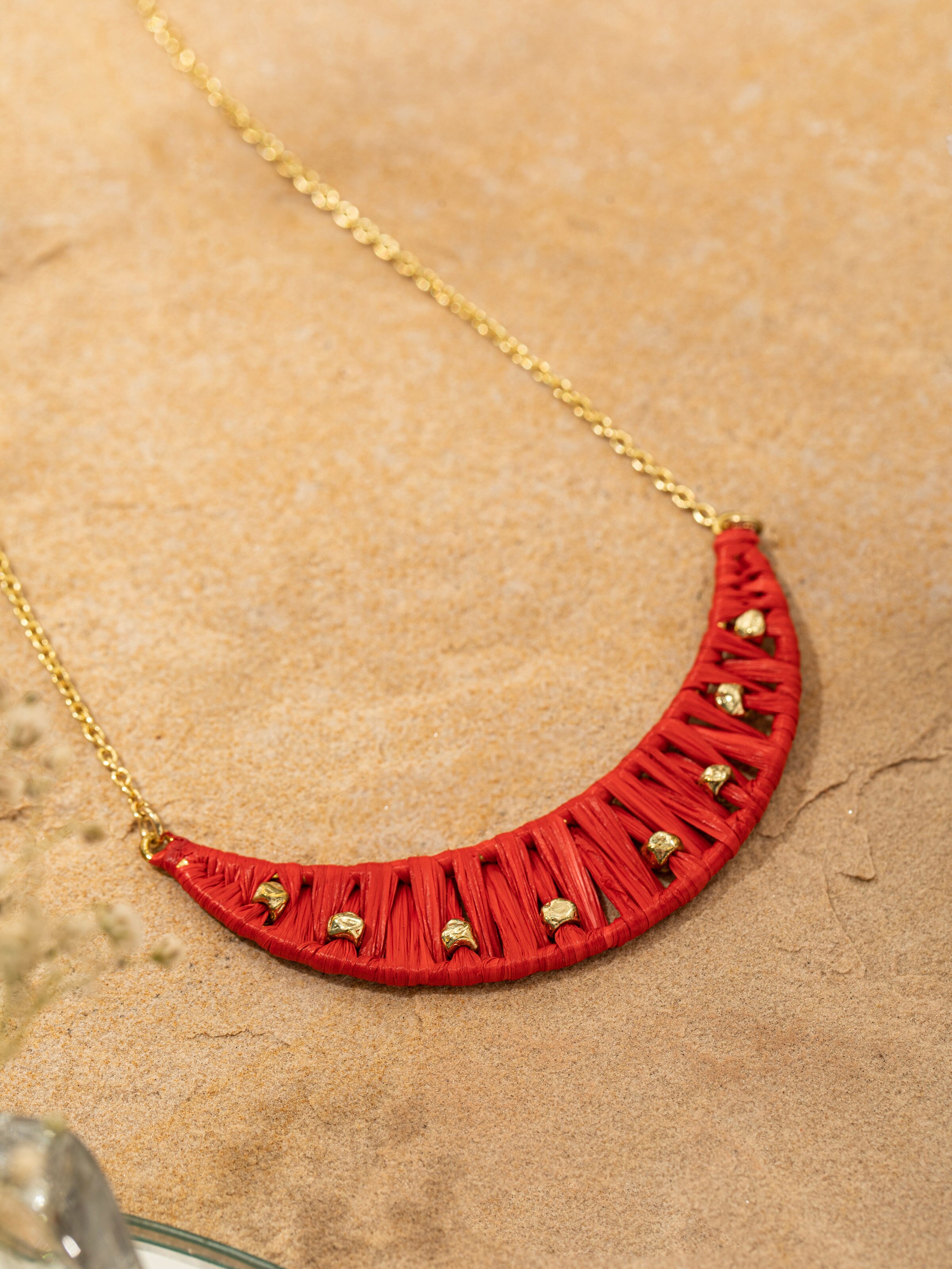 Back view of raffia fibre long necklace highlighting the clasp and design.