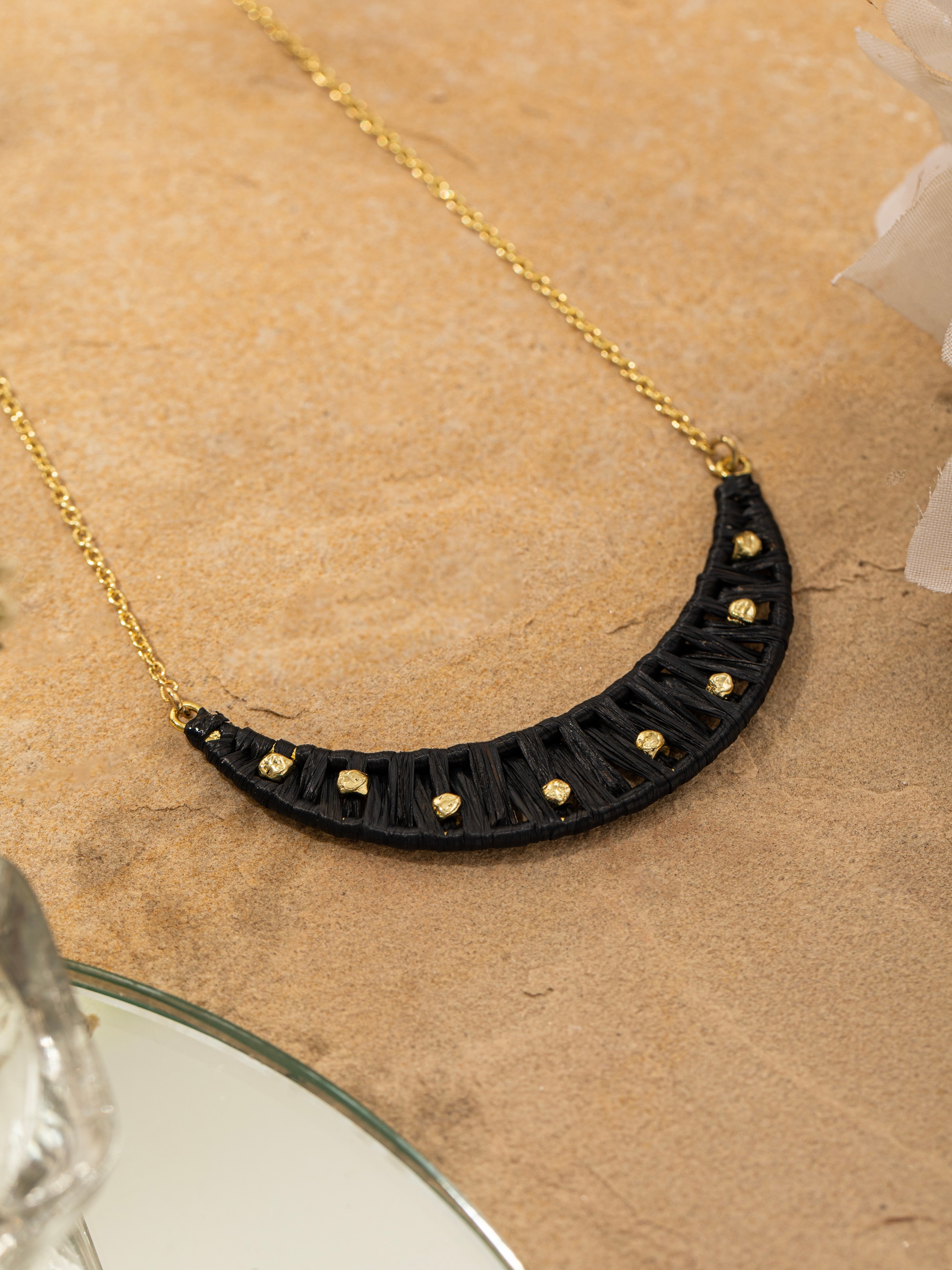 Detailed view of raffia fibre long necklace illustrating its unique texture and stylish design.