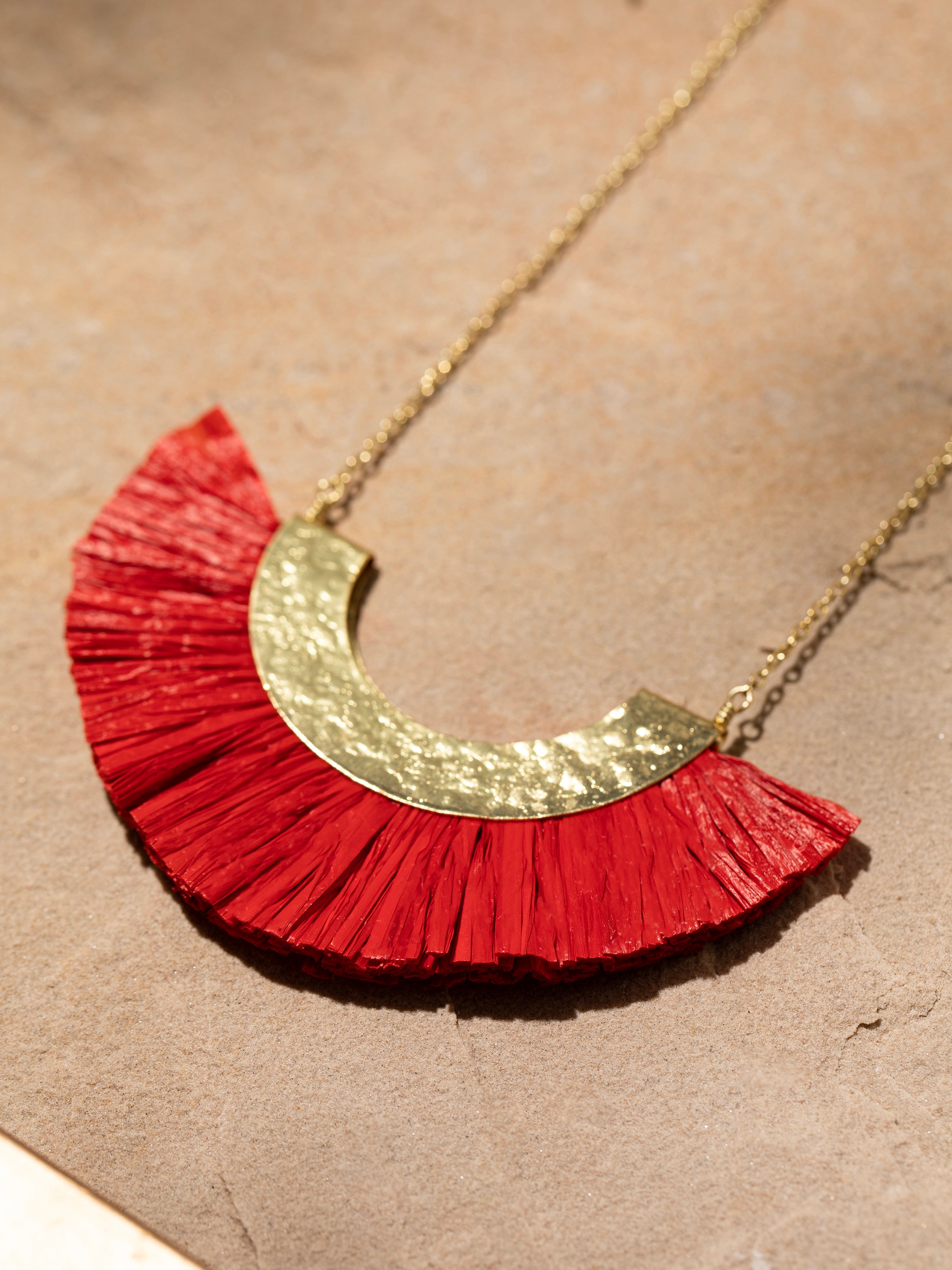 Overhead view of Raffia Fibre Long Necklace featuring the detailed raffia fibre arrangement and vibrant colors.