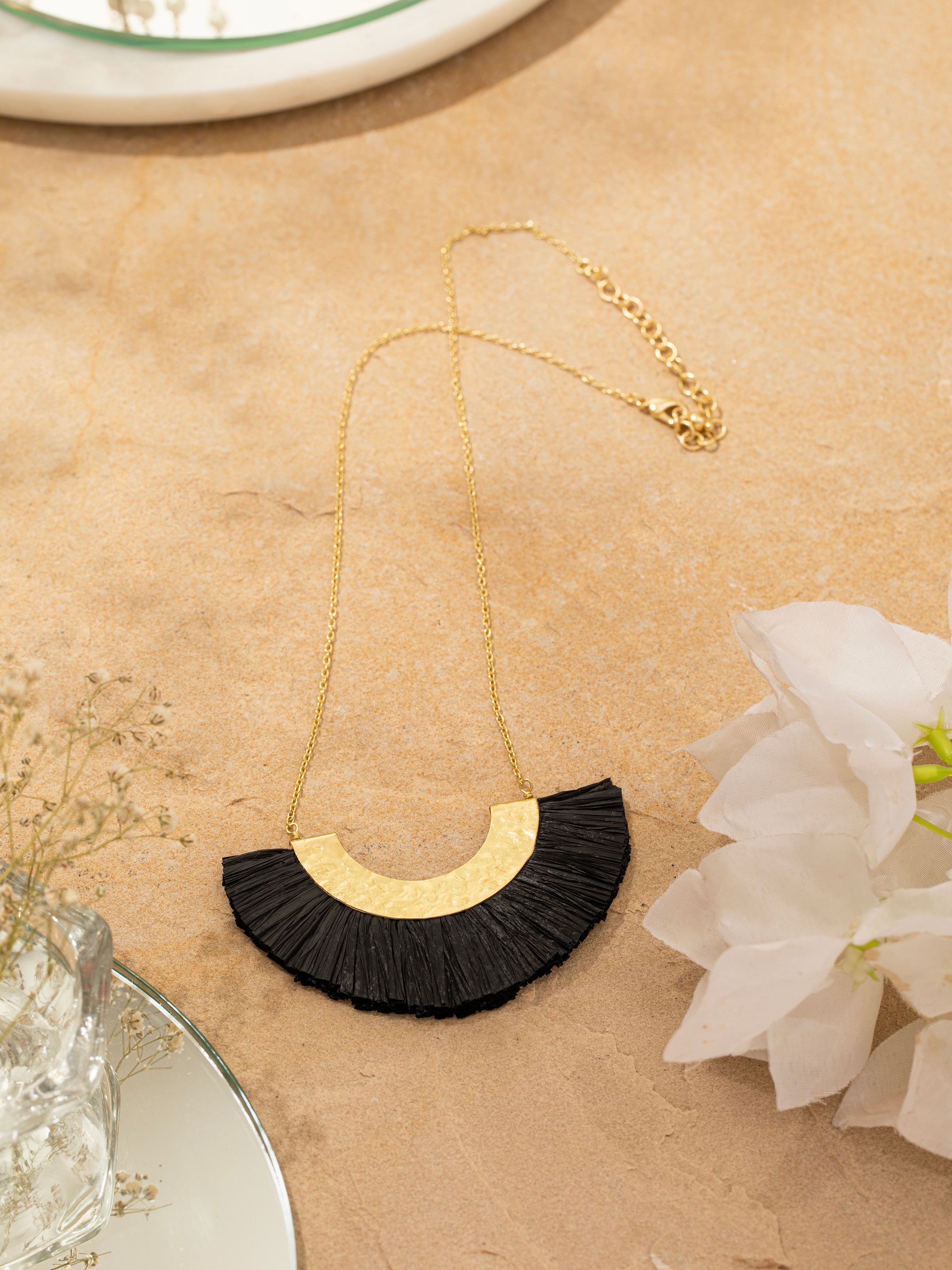 Side view of Raffia Fibre Long Necklace displaying the elegant length and design.