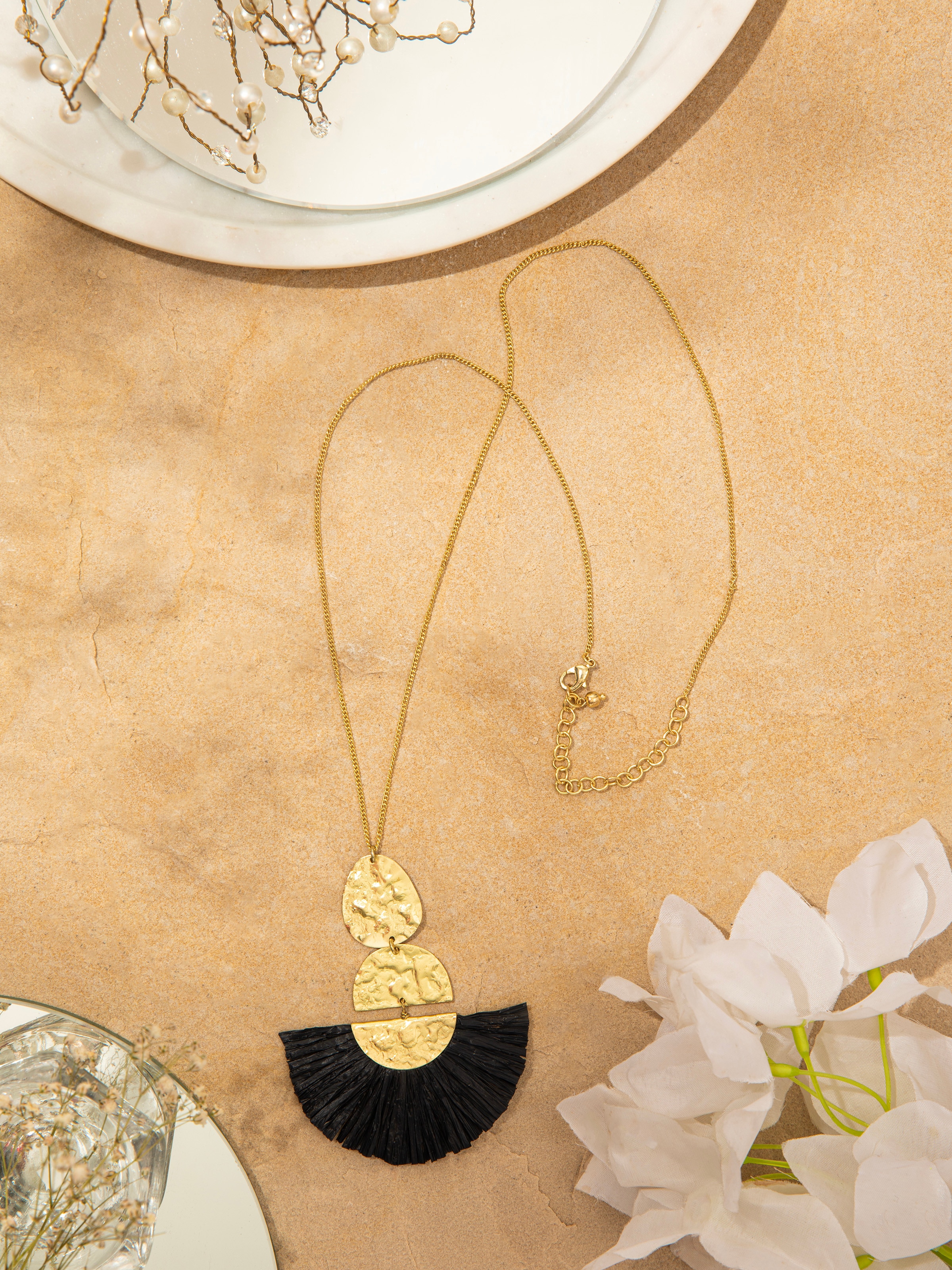 Side view of Raffia fibre long necklace highlighting its unique weave