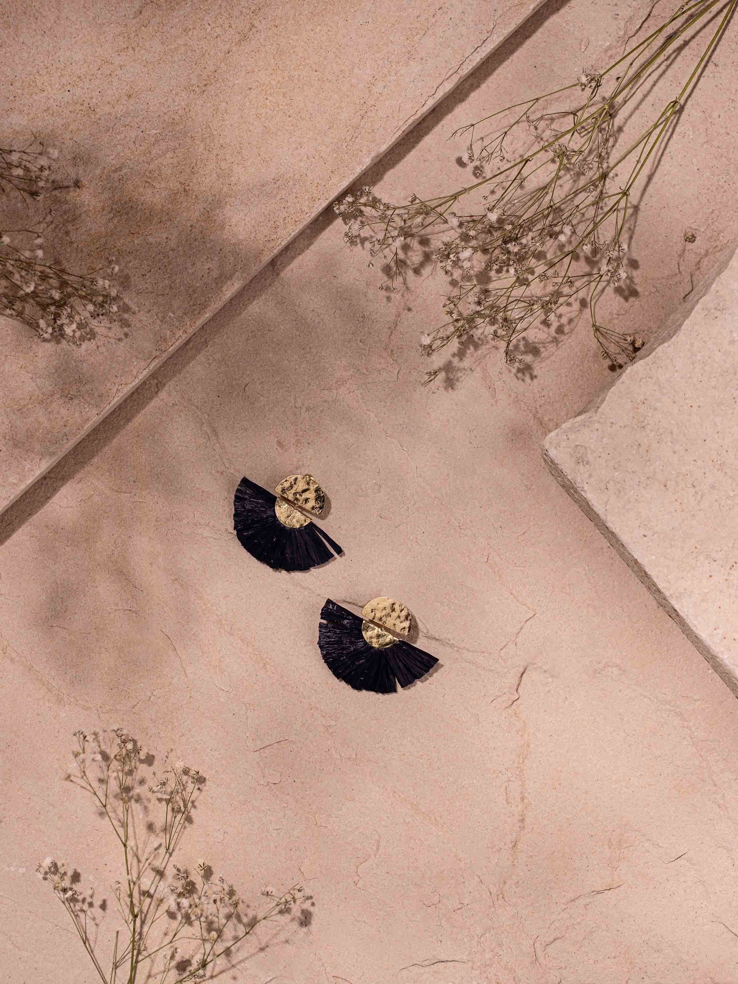 Side view of Raffia Fibre Drop Earrings revealing the elegant drop length and natural fiber texture.