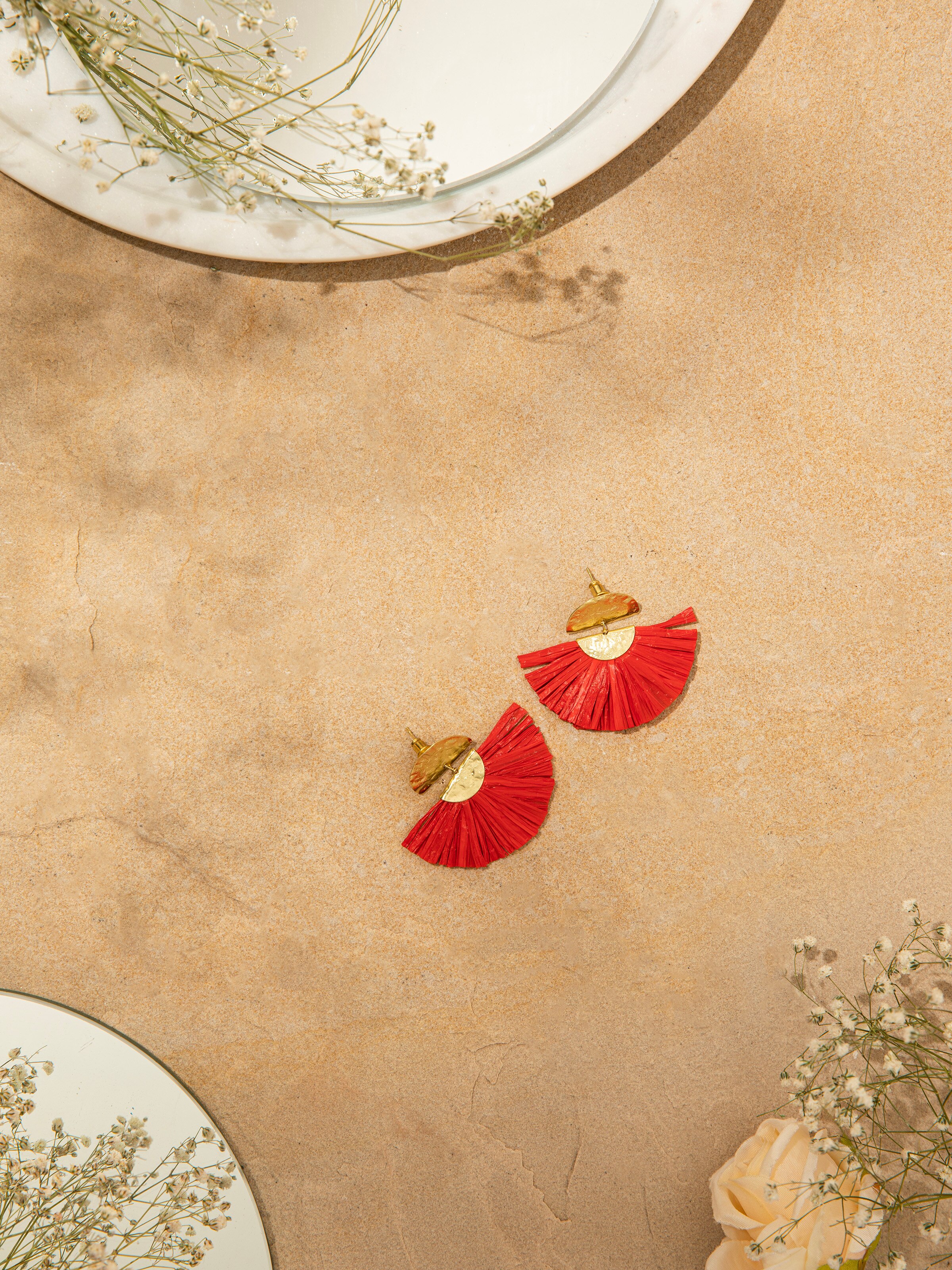 Angled view of Raffia fibre drop earrings showcasing their distinctive design and artisanal craftsmanship