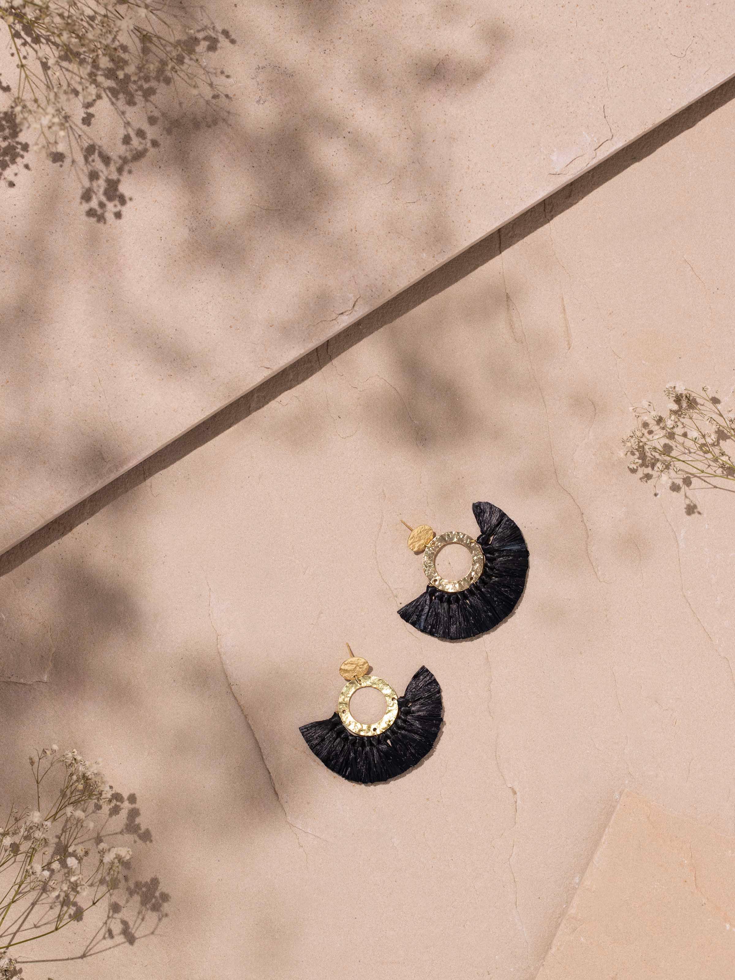 Side view of Raffia Fibre Drop Earrings showcasing the unique design and natural raffia material.