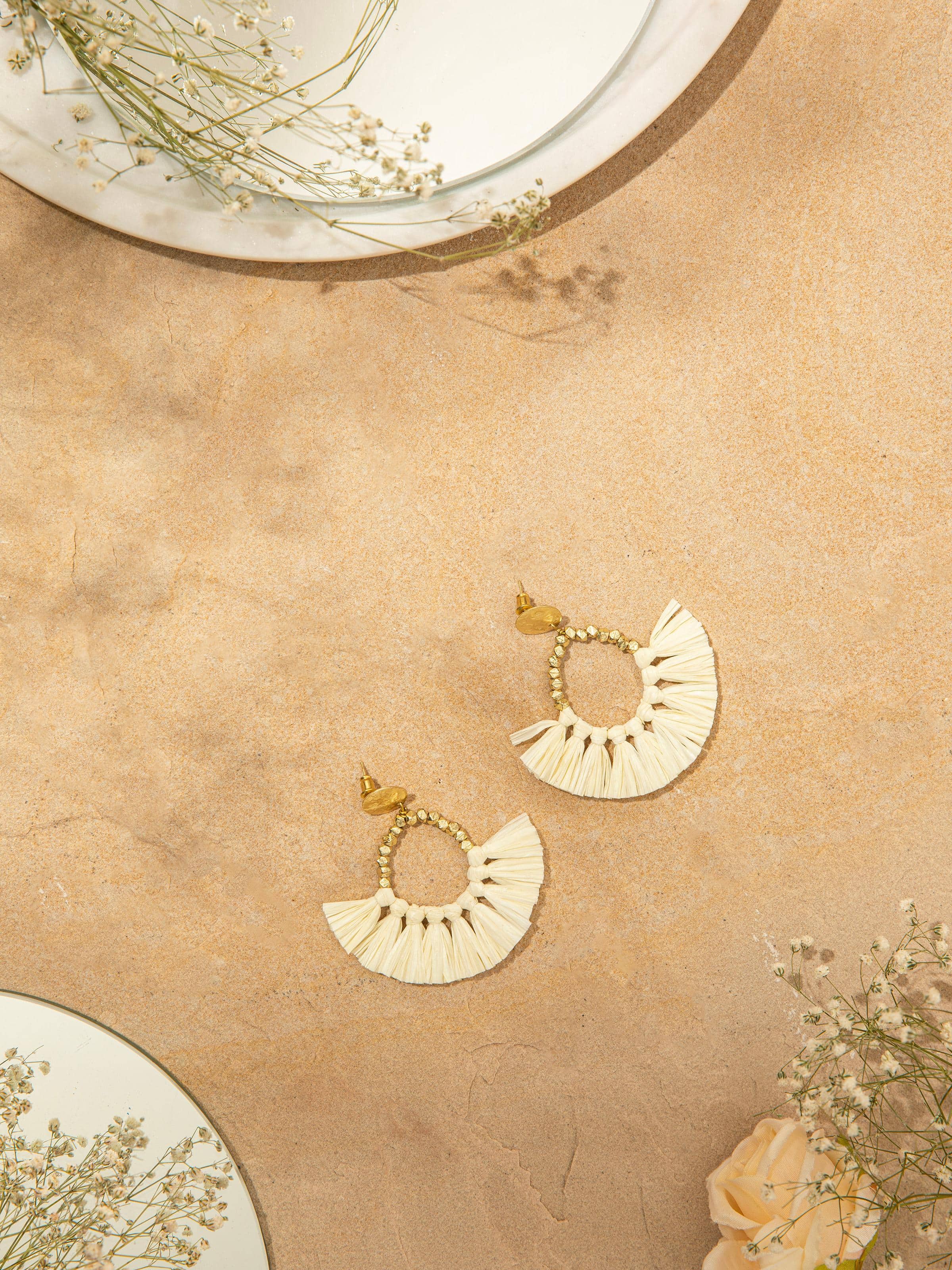 Close-up showing intricate weaving and drop style of earrings