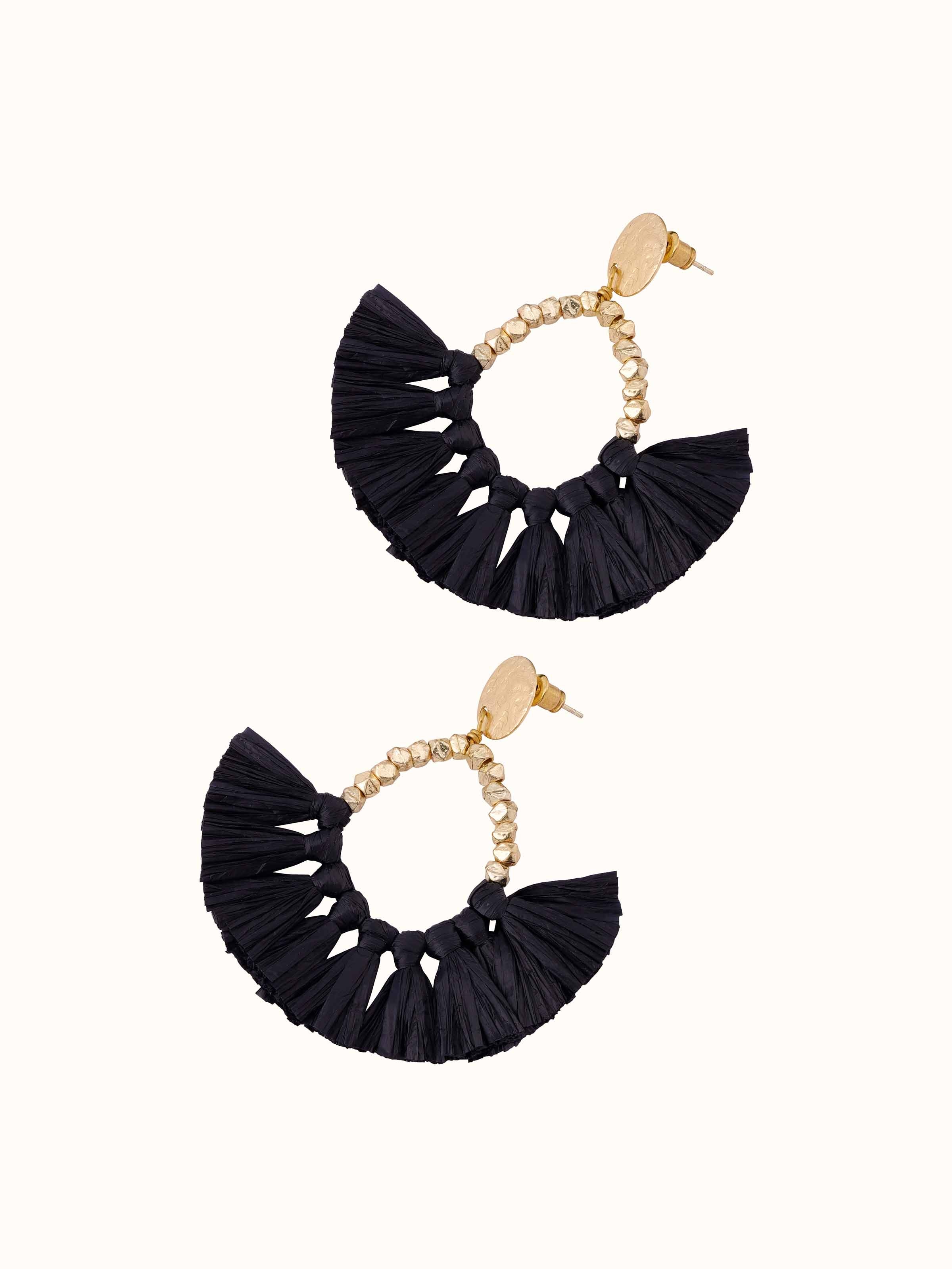 Overhead view of Raffia Fibre Drop Earrings emphasizing the drop style and detailed fibre work.