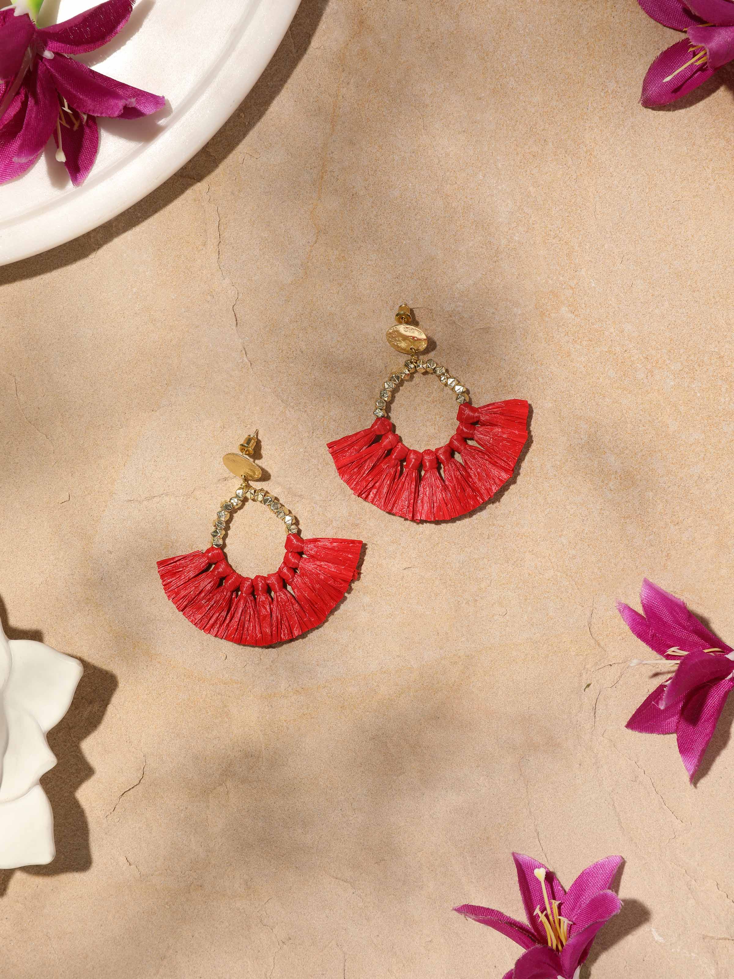 Close-up view of Raffia fibre drop earrings showcasing detailed craftsmanship