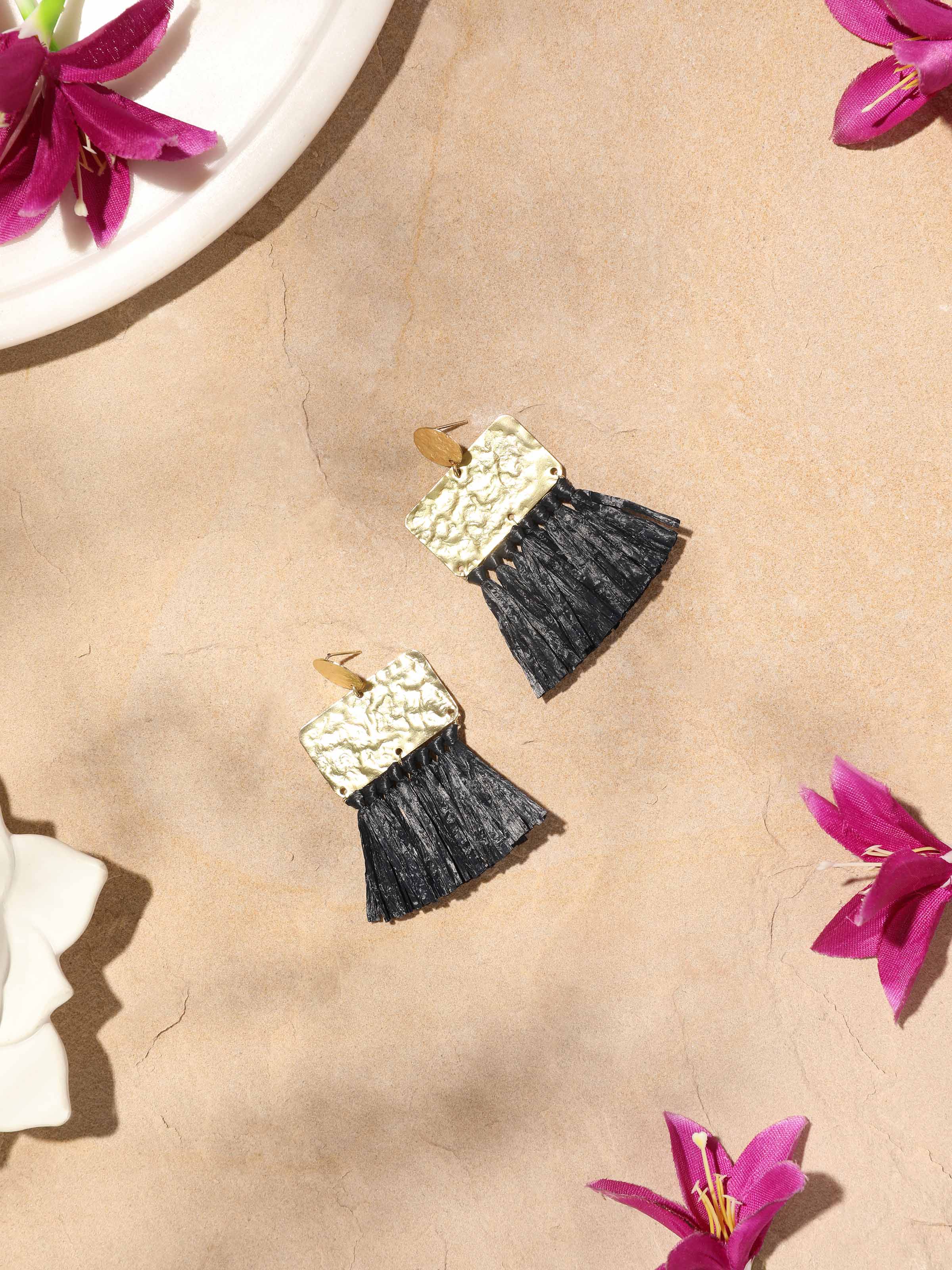 Side view of Raffia Fibre Drop Earrings showing the elegant drop shape and raffia texture.