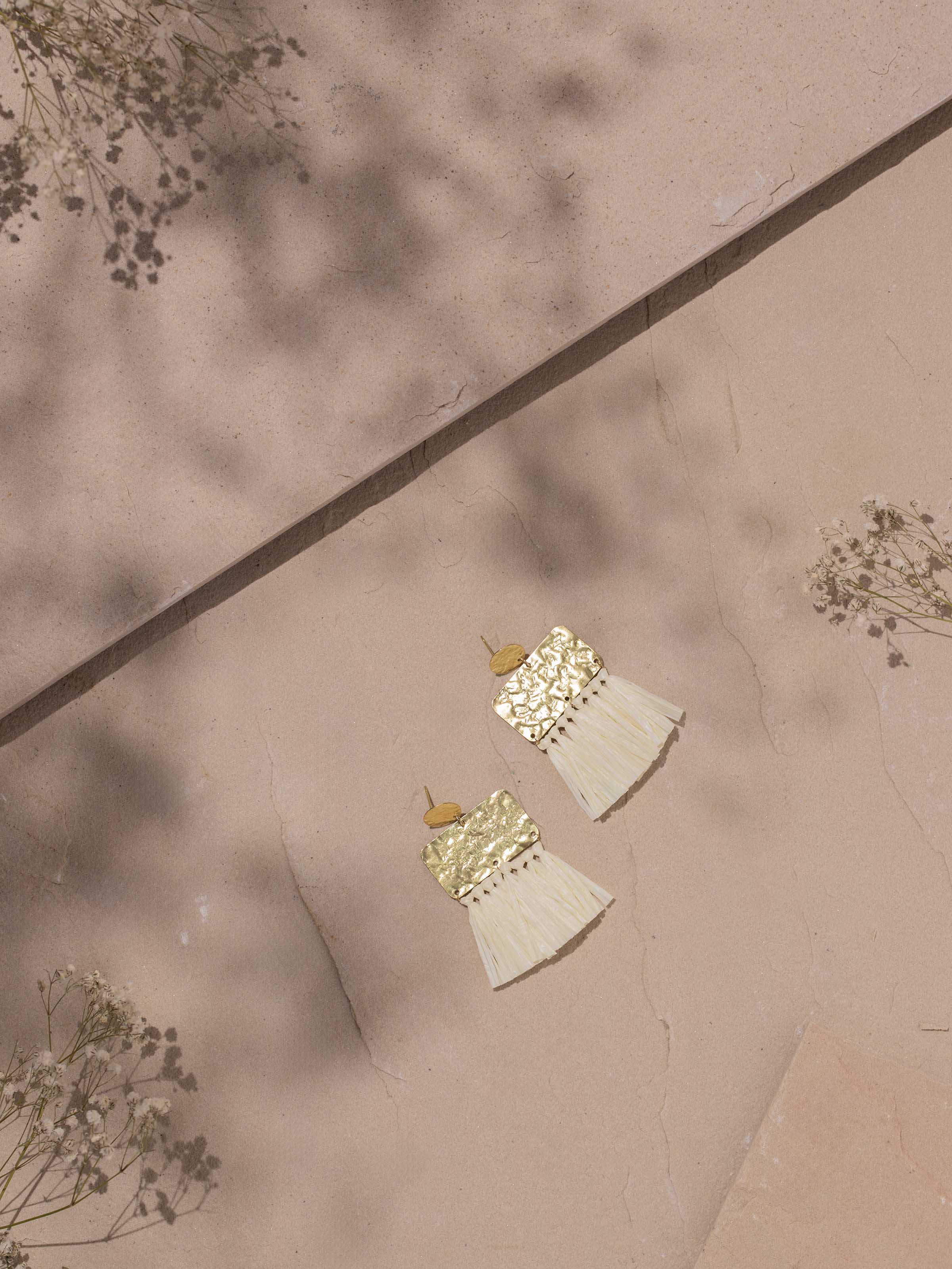 Side view of Raffia Fibre Drop Earrings emphasizing the natural fibre and elegant drop design.