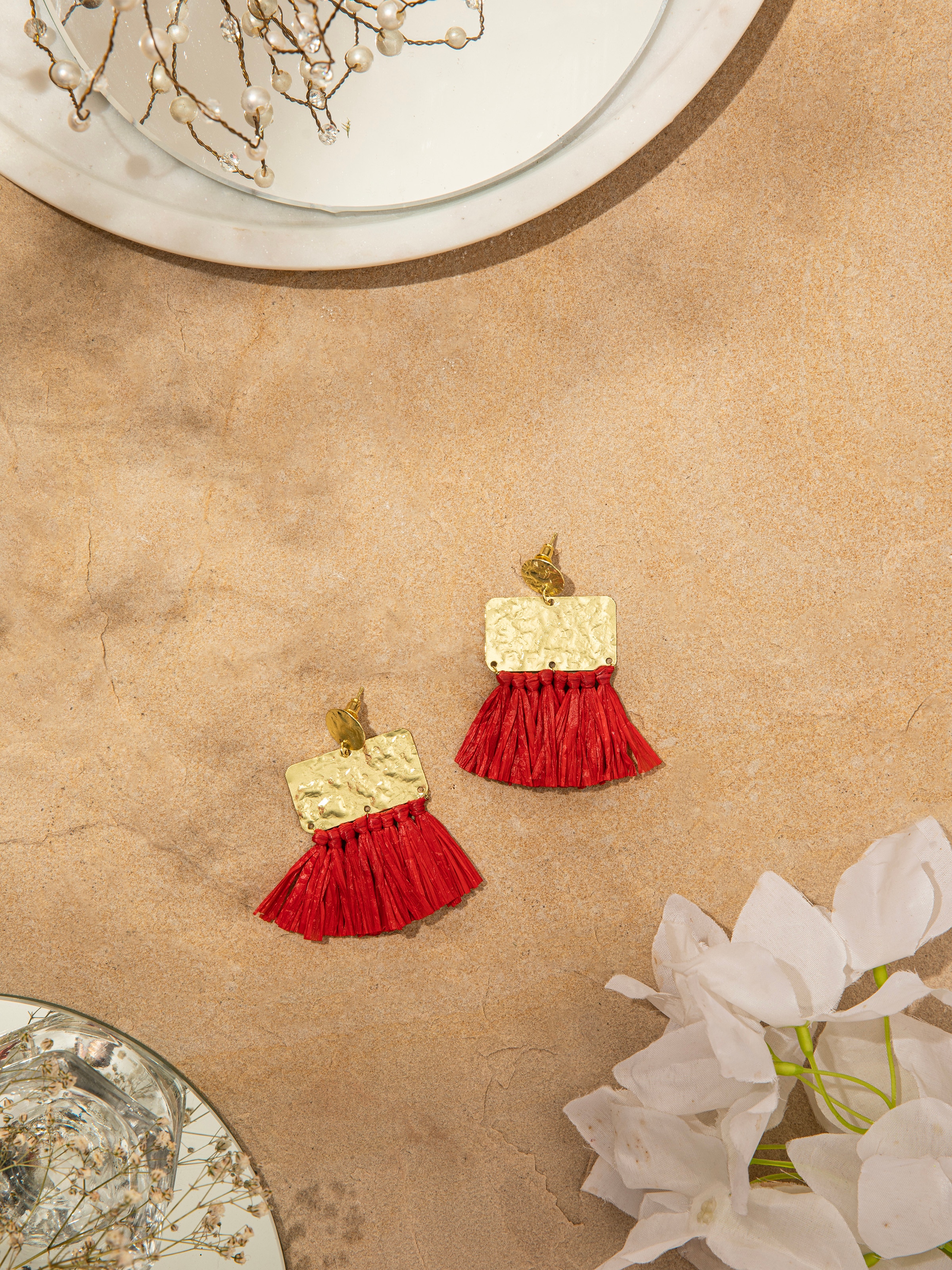 Side view of Raffia Fibre Drop Earrings emphasizing their elegant drop design.