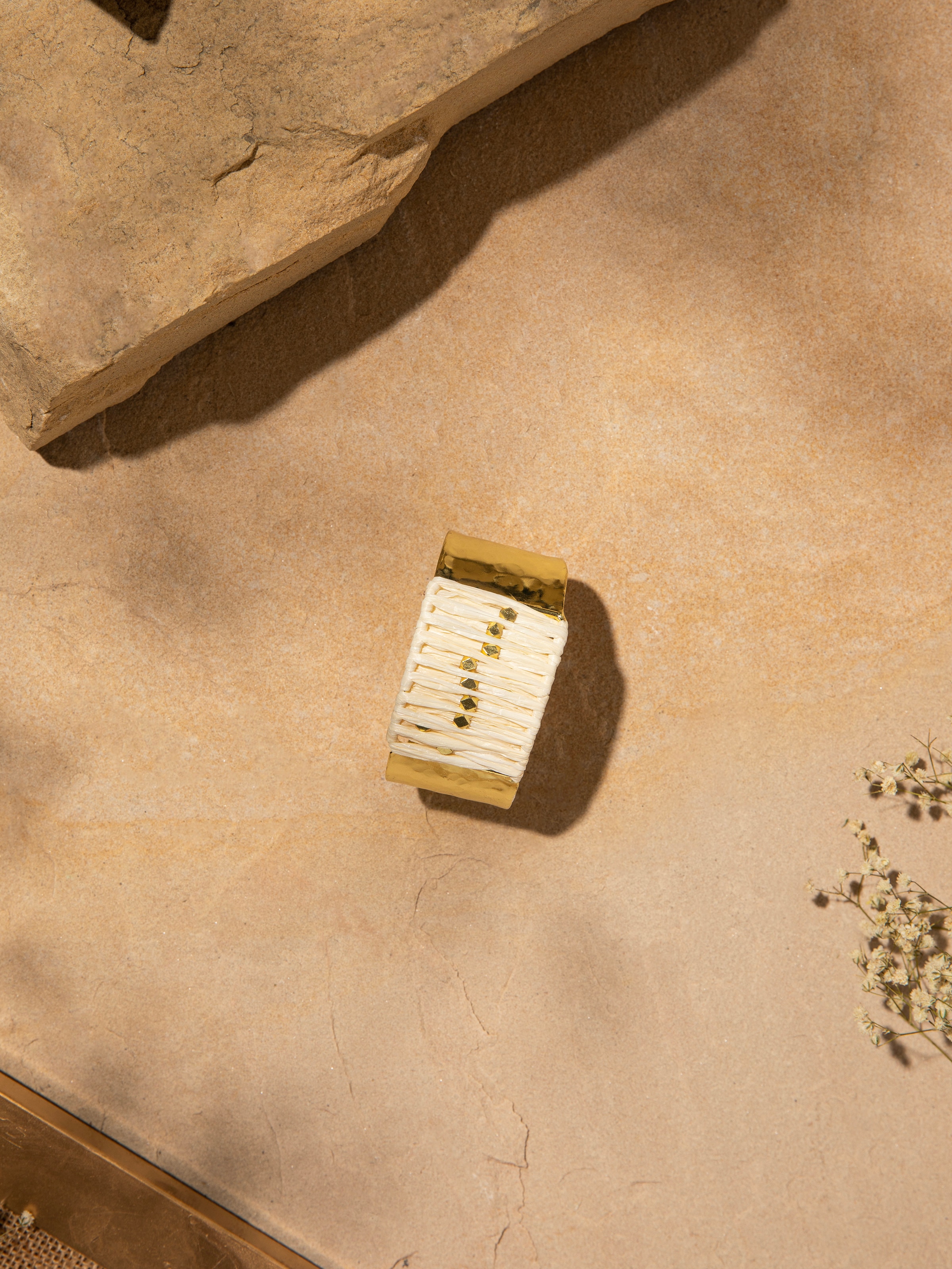 Side view of Raffia fibre hand cuff highlighting its unique design.