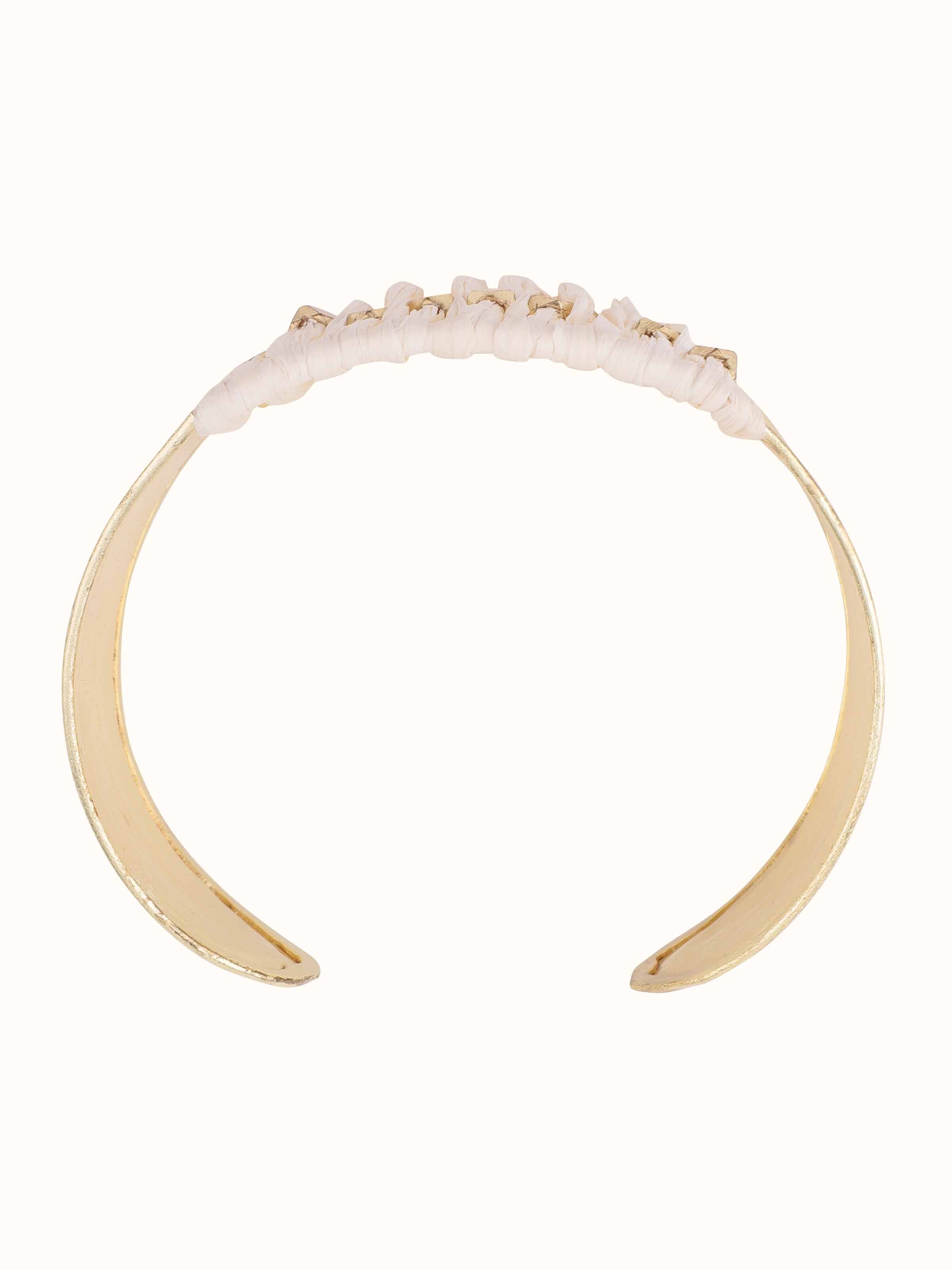 Angled view of Raffia fibre hand cuff showcasing its texture and style.