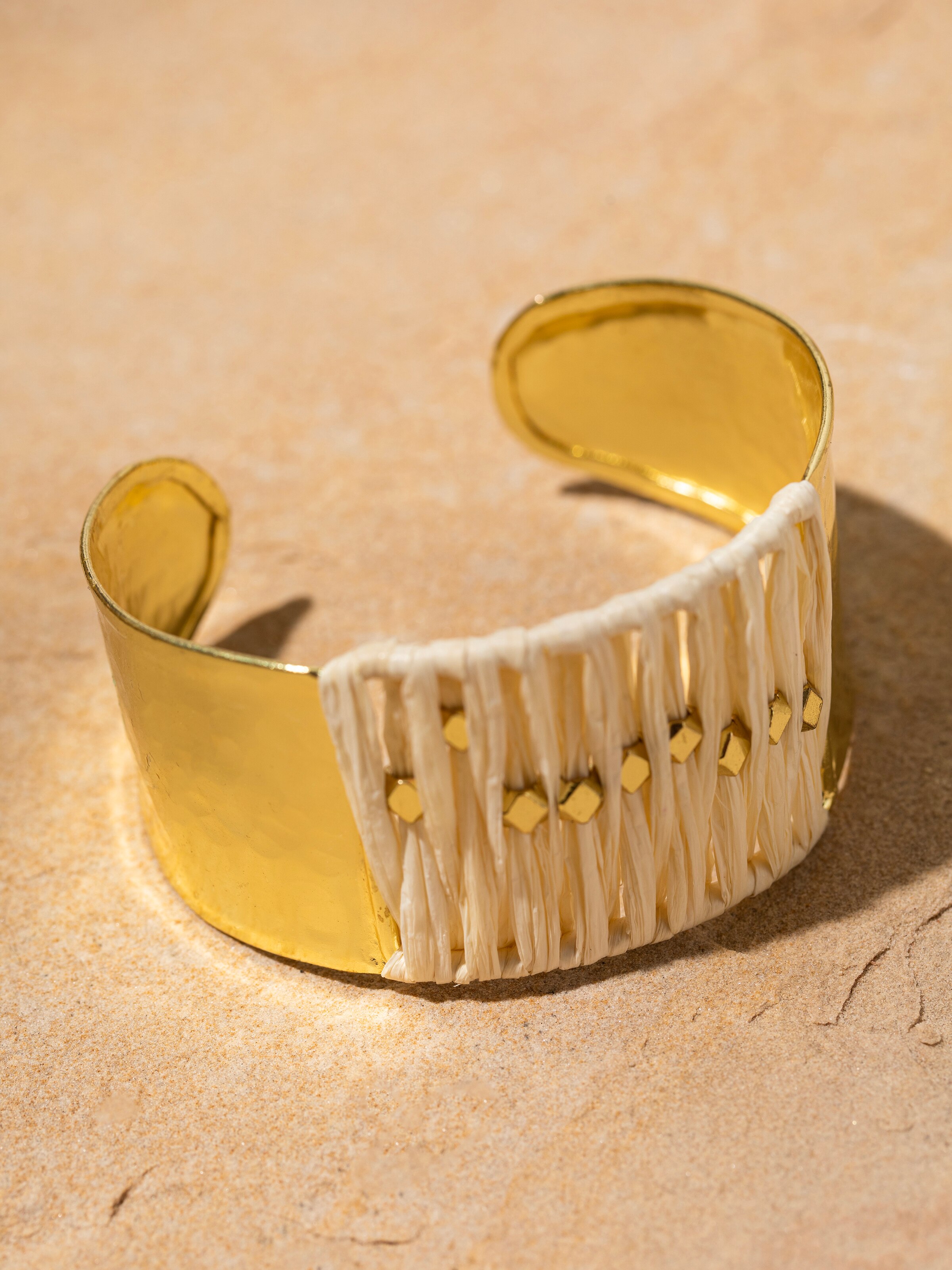 Detailed view of Raffia fibre hand cuff with natural fiber texture.
