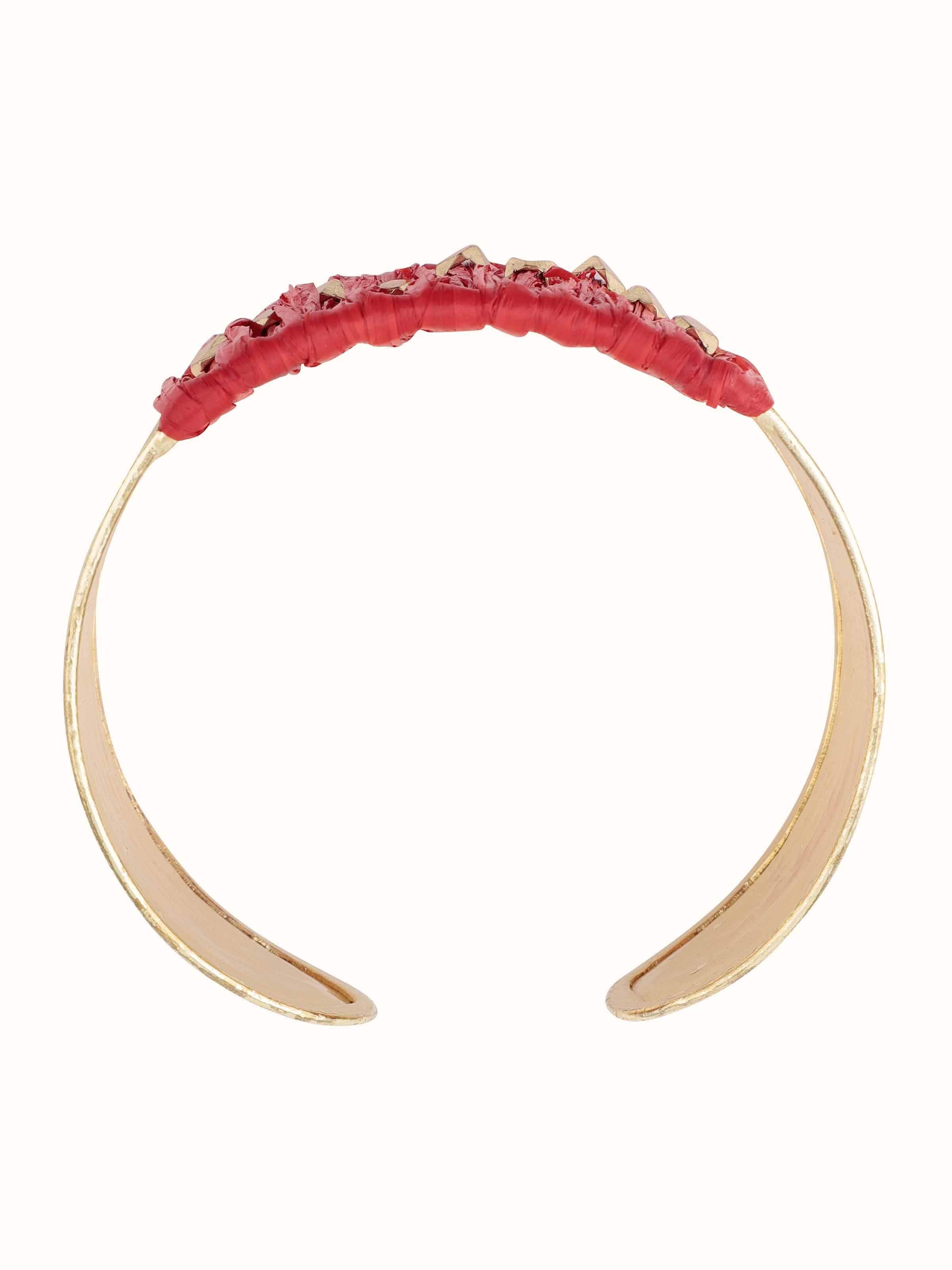 Overhead view capturing the circular structure and tactile finish of the Raffia Fibre Hand Cuff.