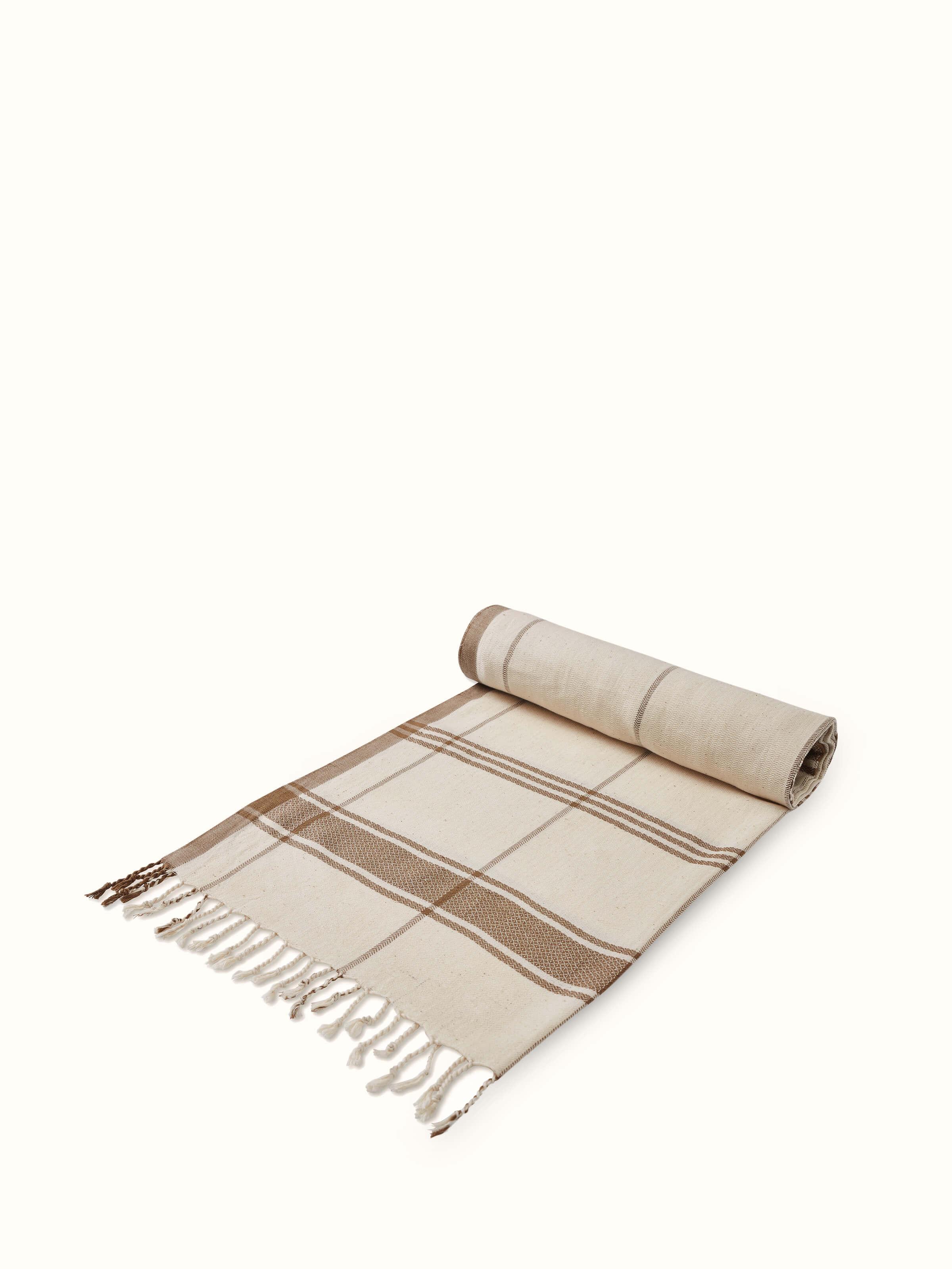 Angled view of Sarvika Brown Checks Cotton Bath Towel (L), displaying the full design and pattern.