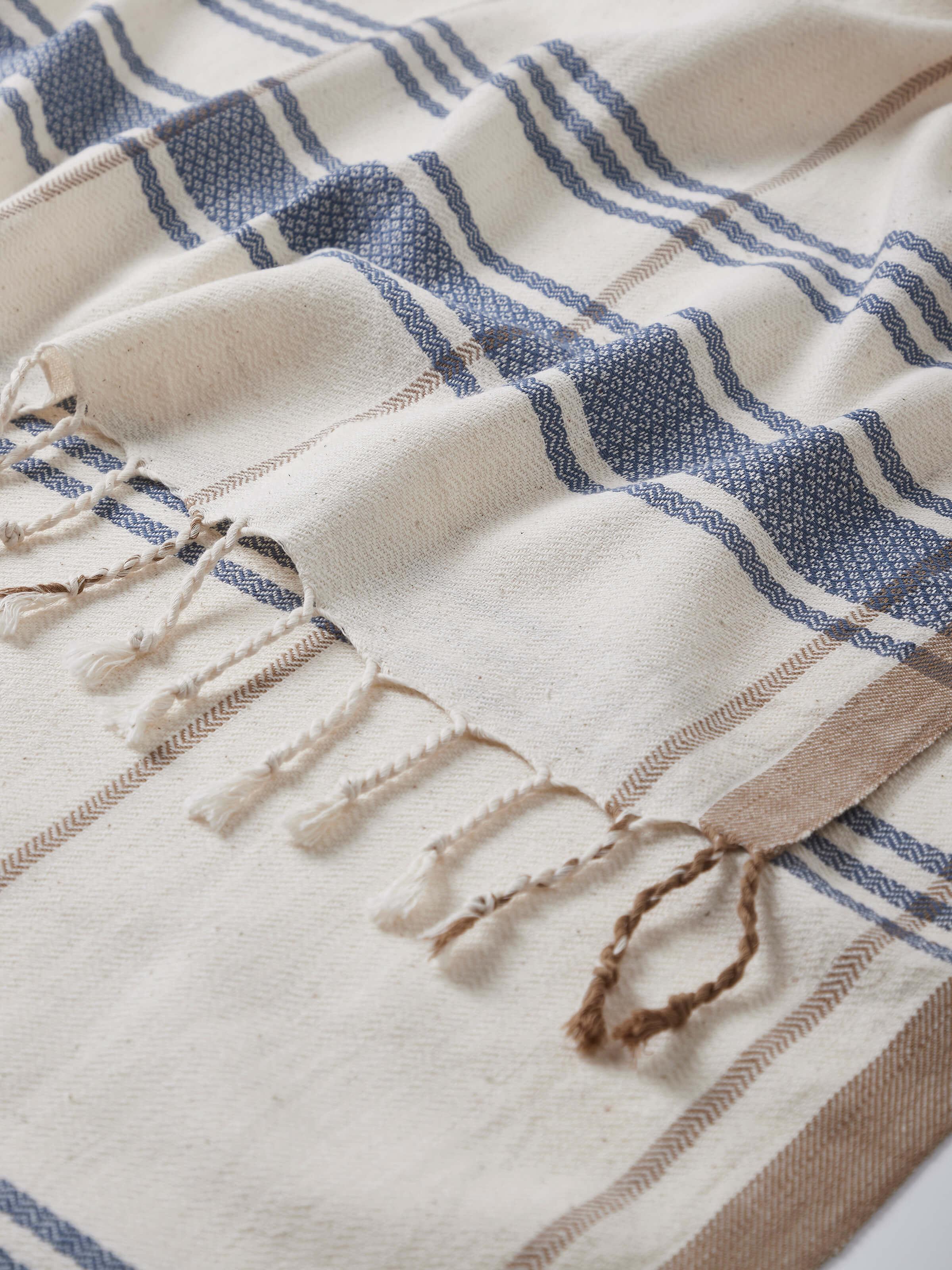 Sarvika blue checks cotton bath towel (M) folded to show its texture and pattern.
