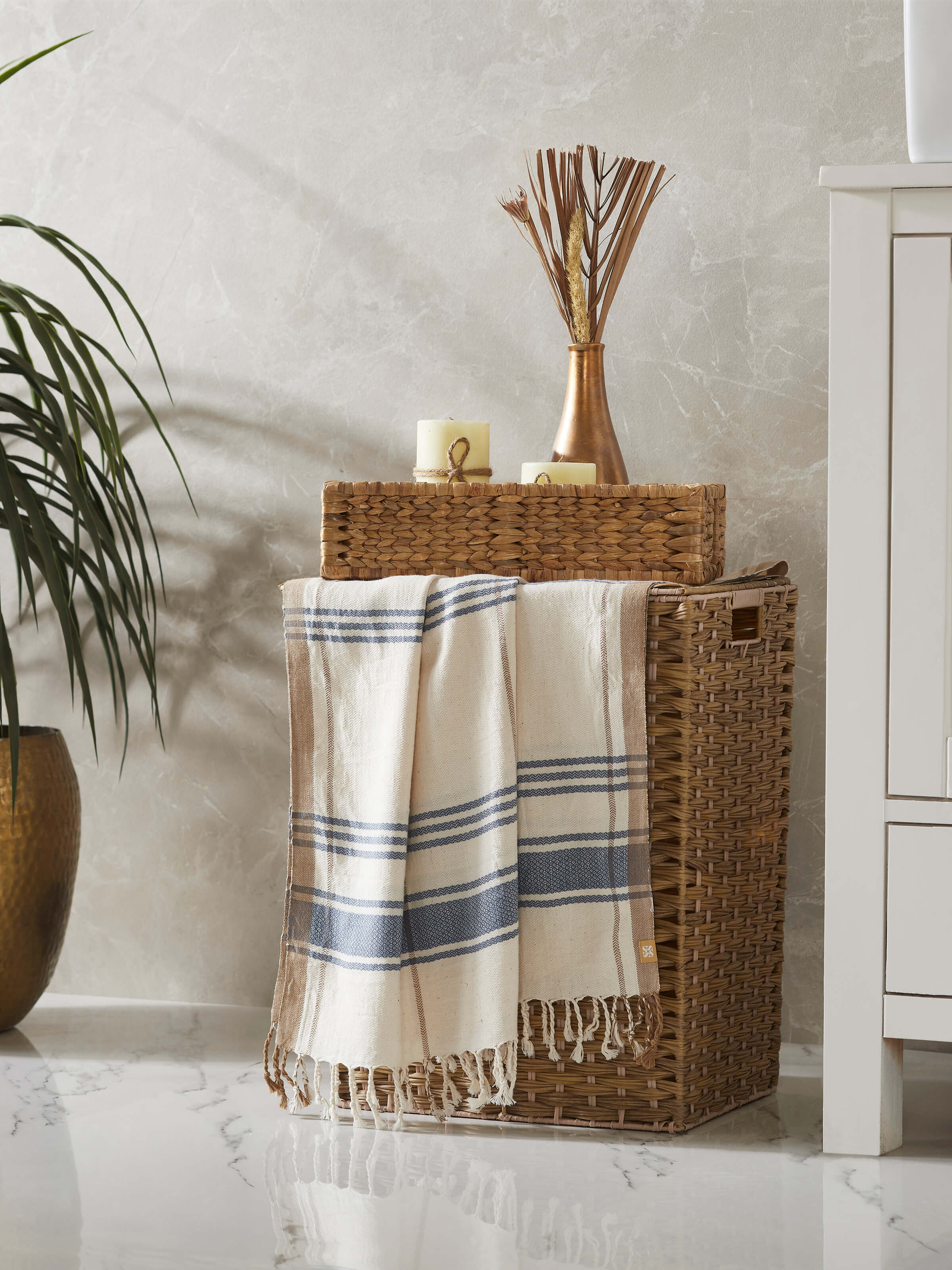 Side view of Sarvika blue checks cotton bath towel (L) emphasizing its checkered design and absorbent fabric.