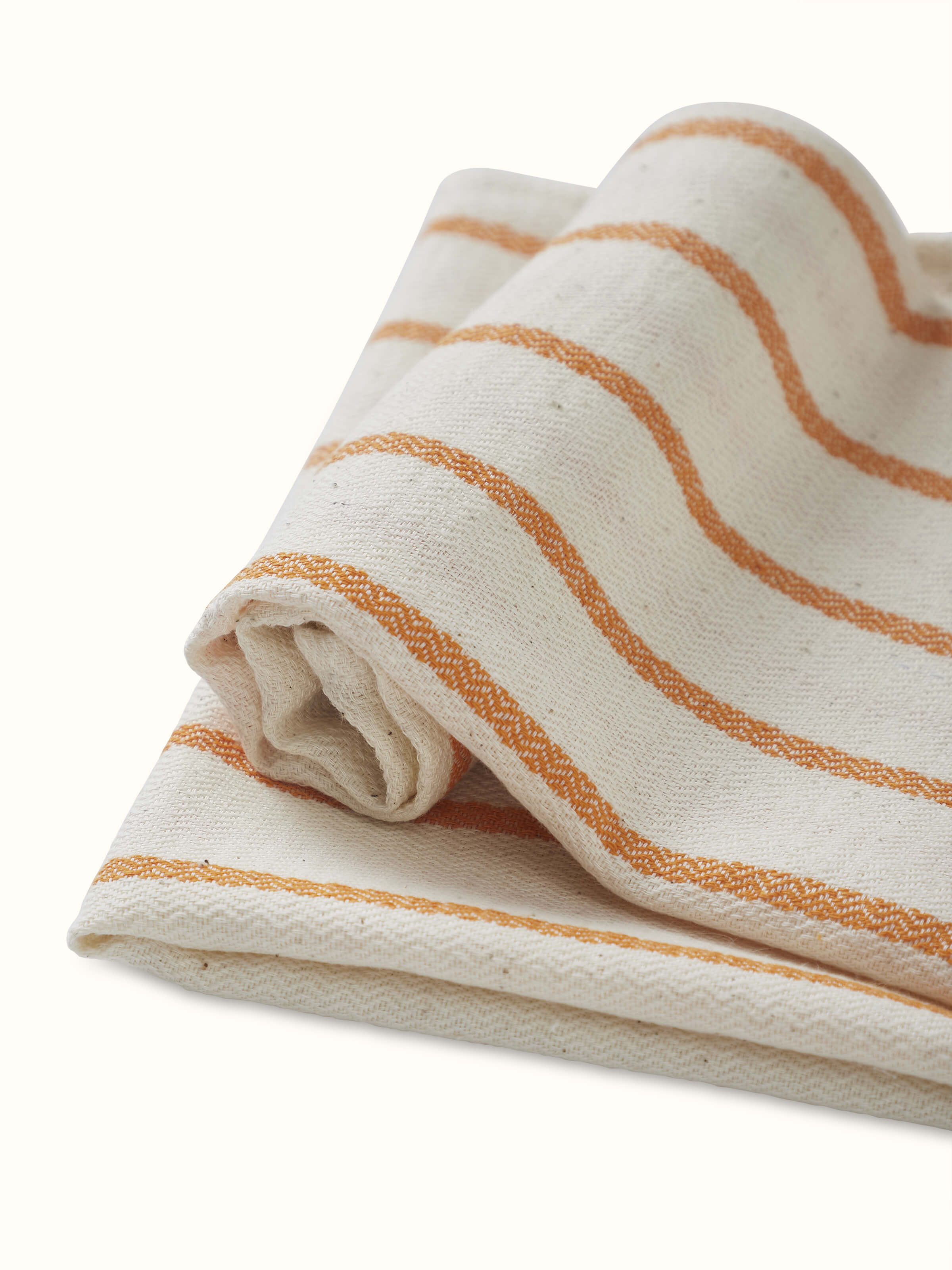 Samitha rust stripe cotton hand towel, showing the texture and stripes in a close-up view.
