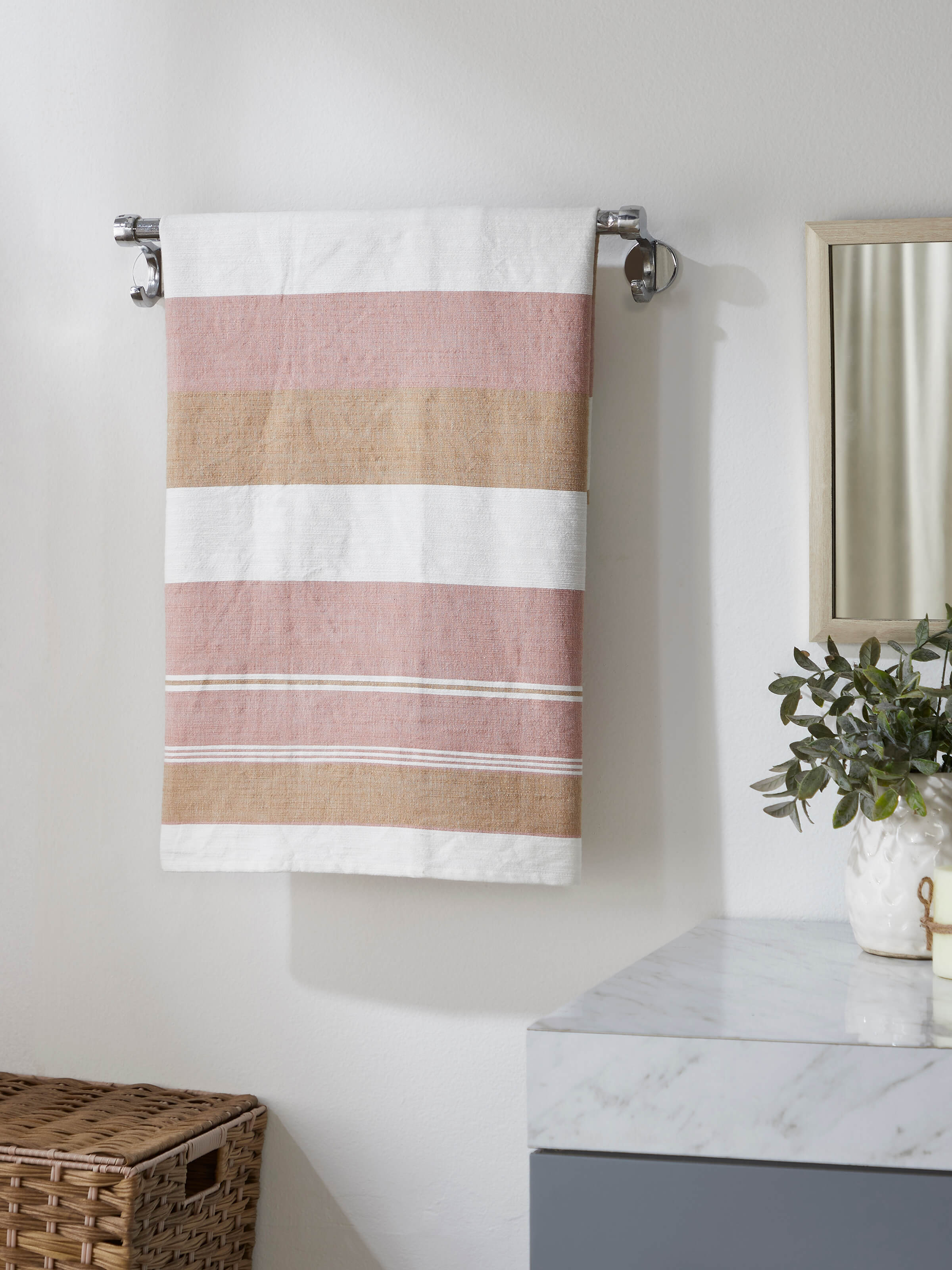 Close-up of a large maroon cotton bath towel highlighting its luxurious fabric and refined striped design.