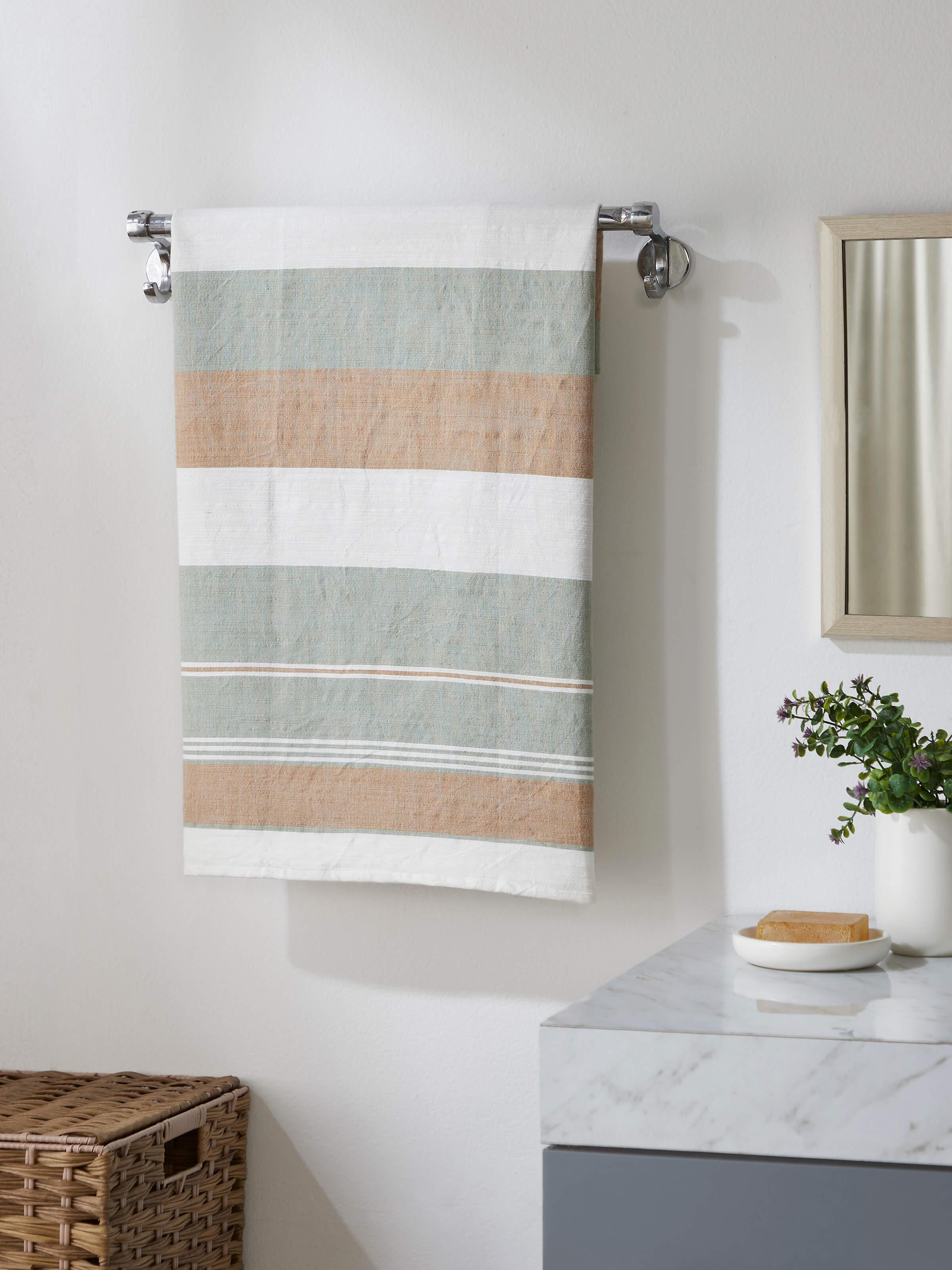 Close-up of Aishani green stripe cotton bath towel, highlighting the texture and green stripe pattern.