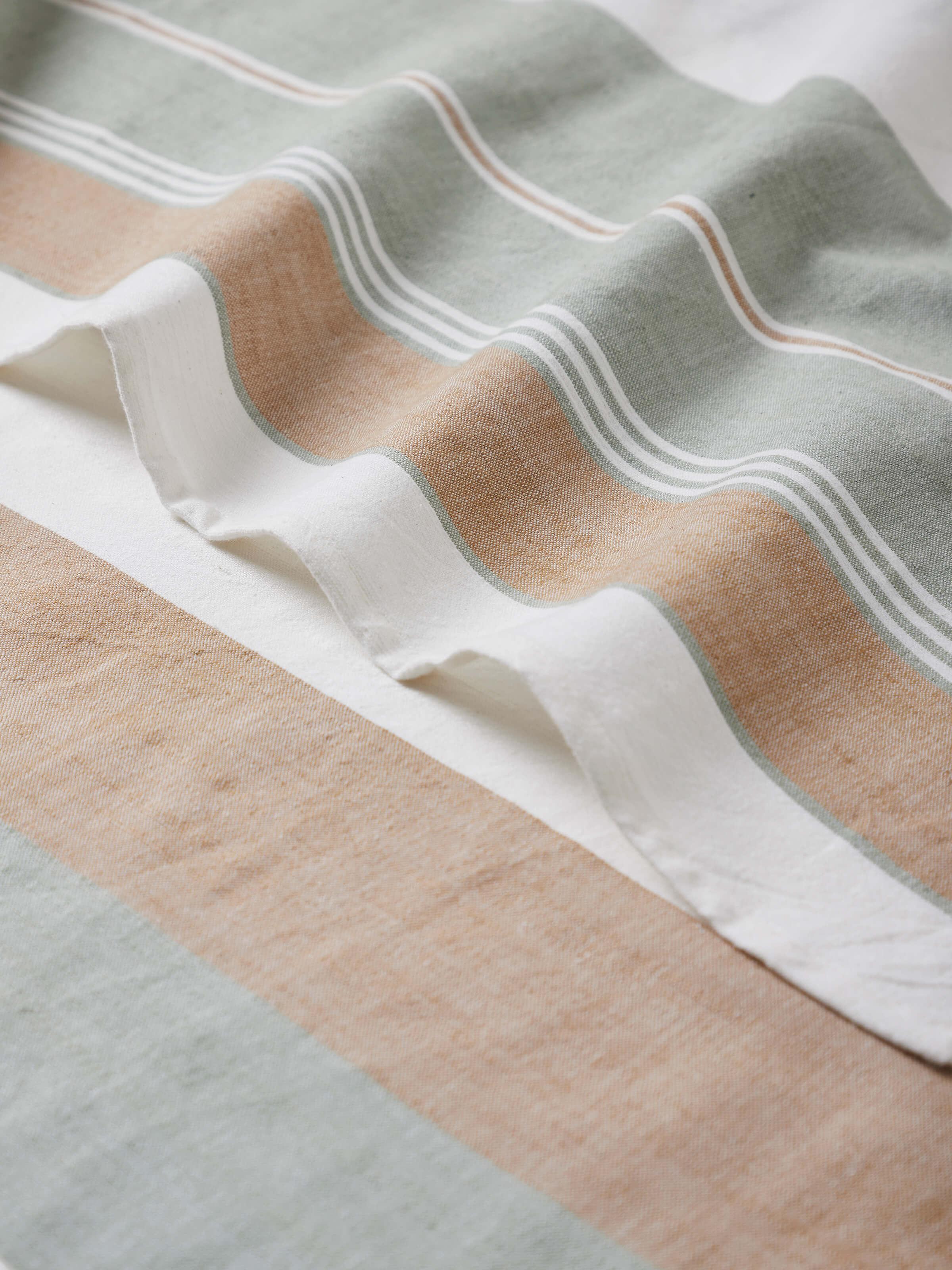 Detailed view of Aishani green stripe cotton bath towel, showing the towel's texture and stripe detail.