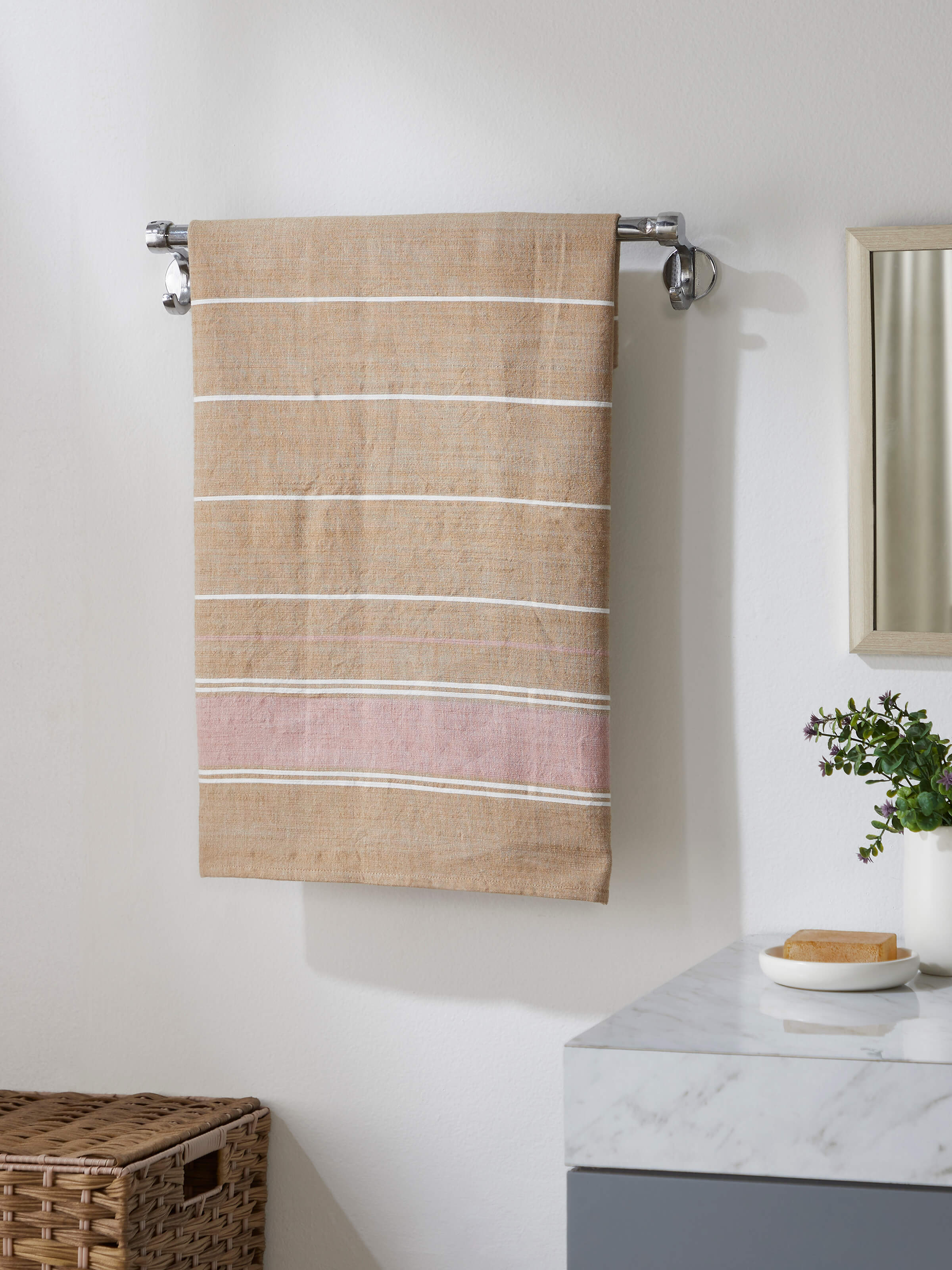 Side view of Samistha brown stripe cotton striped bath towel (L) highlighting its thickness and stripe design