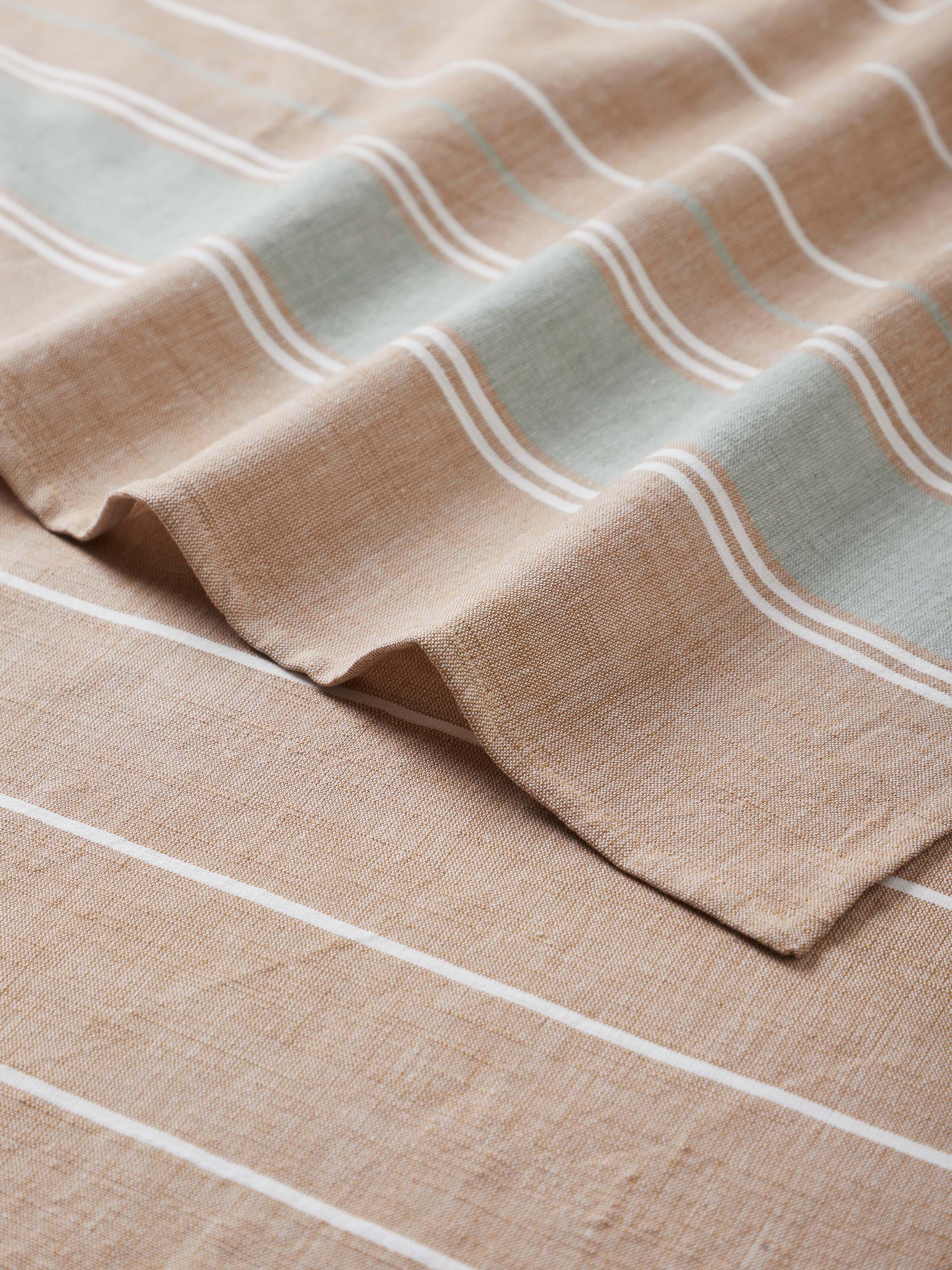 Angled view of Samistha Green Stripe Cotton Striped Bath Towel (L), displaying its full stripe design and cotton fabric.