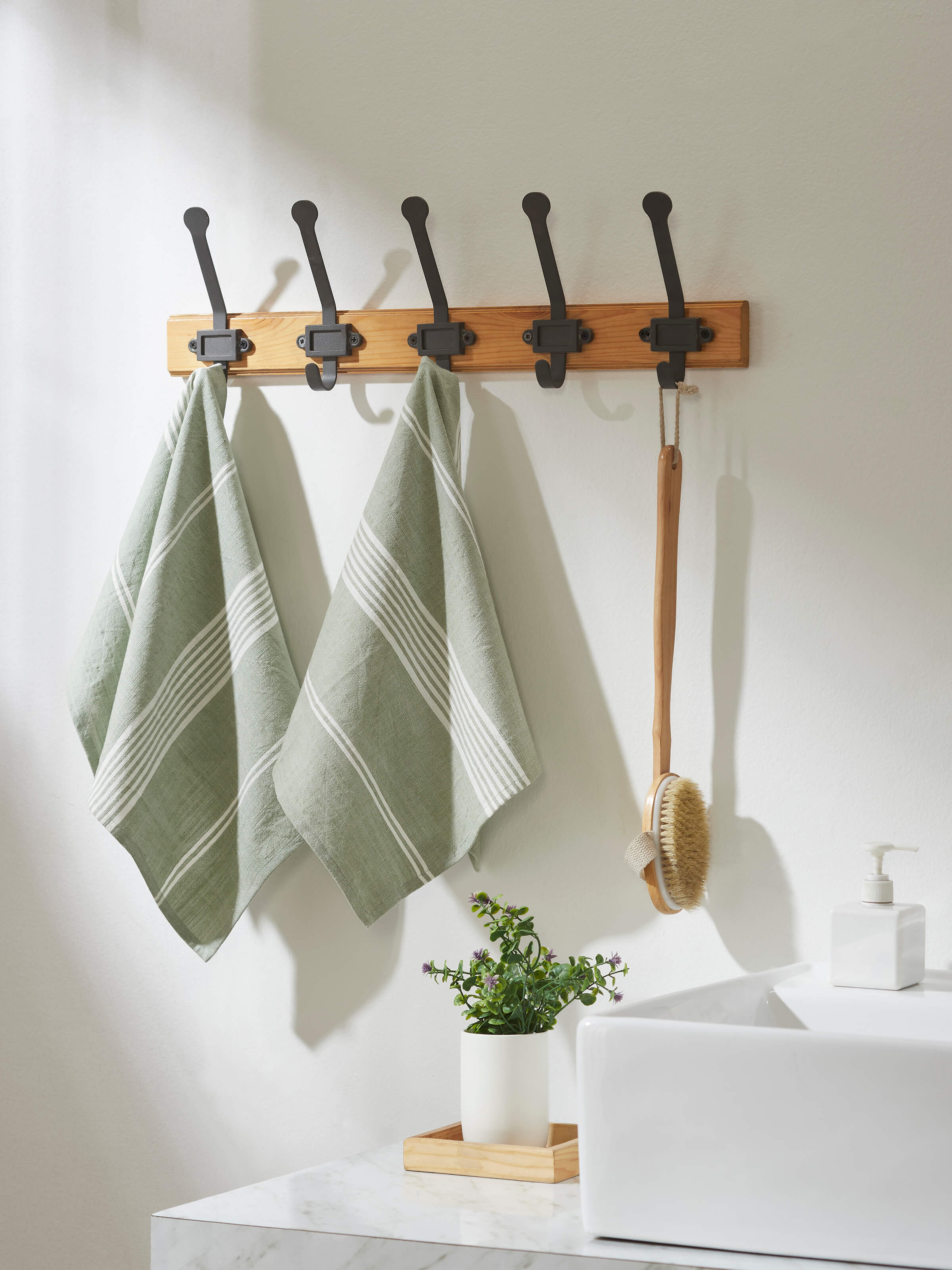 Close-up of Simhi green stripe cotton hand towels, highlighting the stripe pattern and soft cotton fabric.