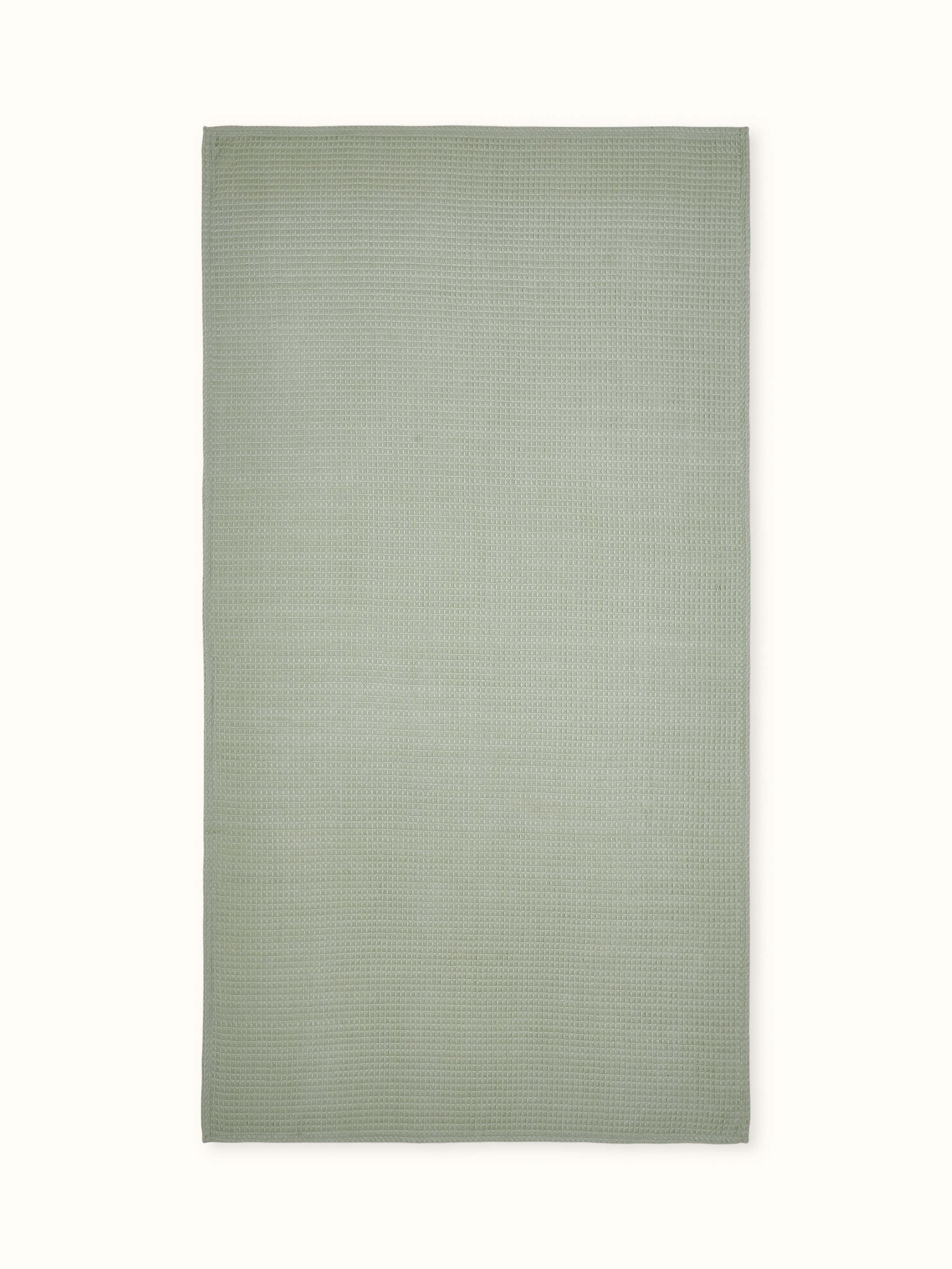 Front view of Amala waffle green solid cotton bath towel (M), showcasing the waffle texture and vibrant green color.