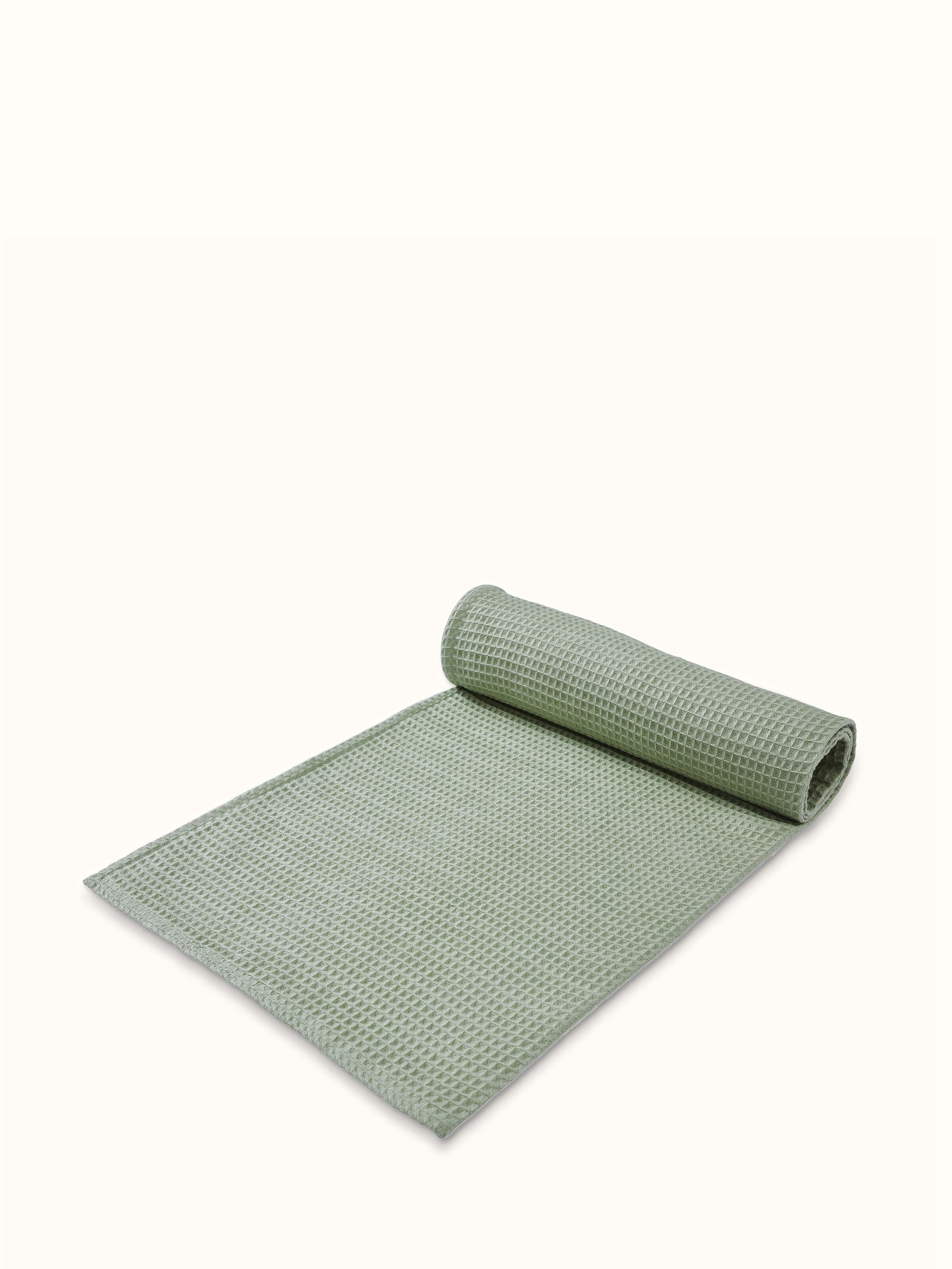 Detailed view of Amala waffle green solid cotton bath towel (M), focusing on the texture and quality of the cotton material.