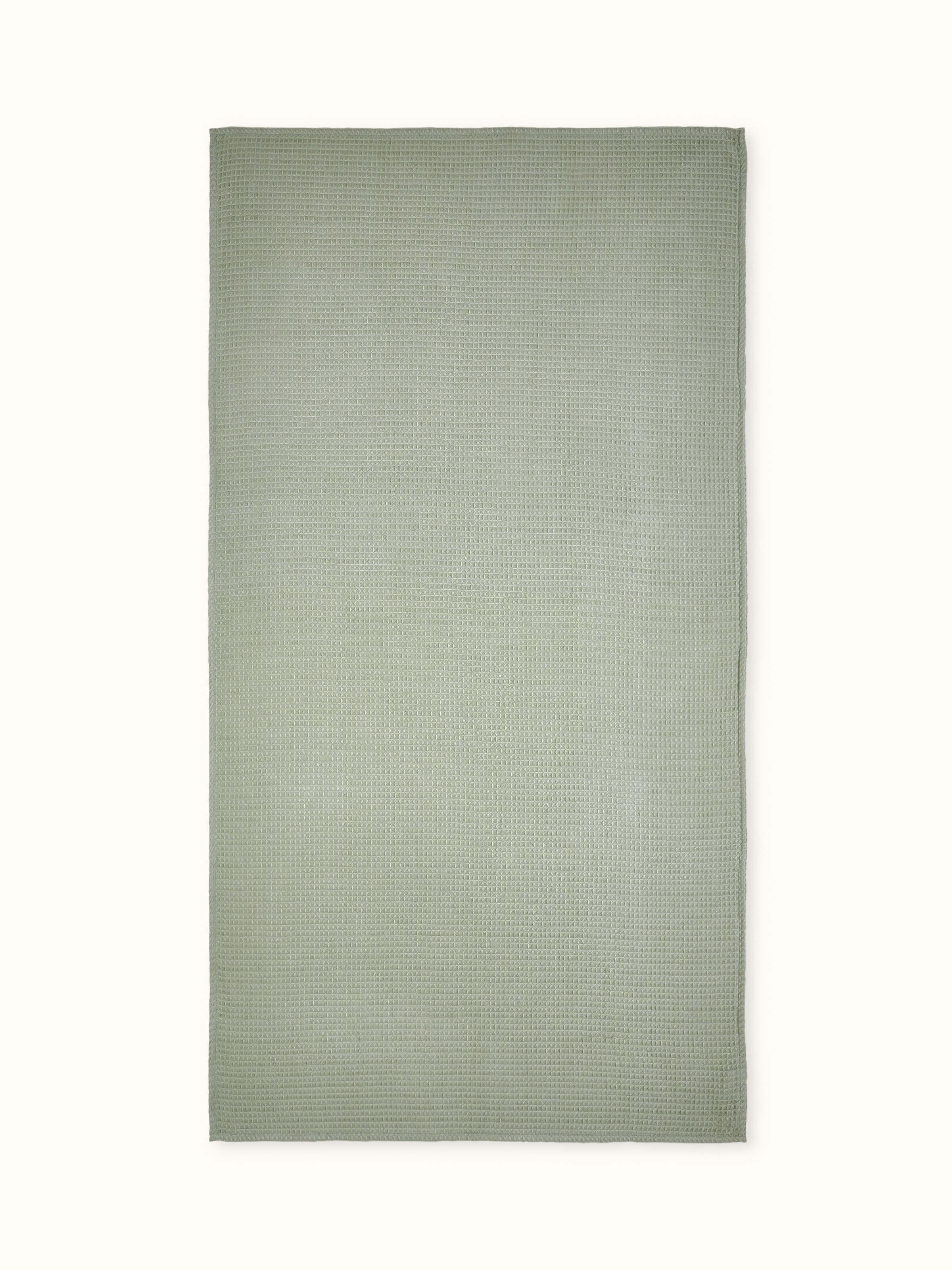 Full view of Amala waffle green solid cotton bath towel showcasing its waffle texture and vibrant green color