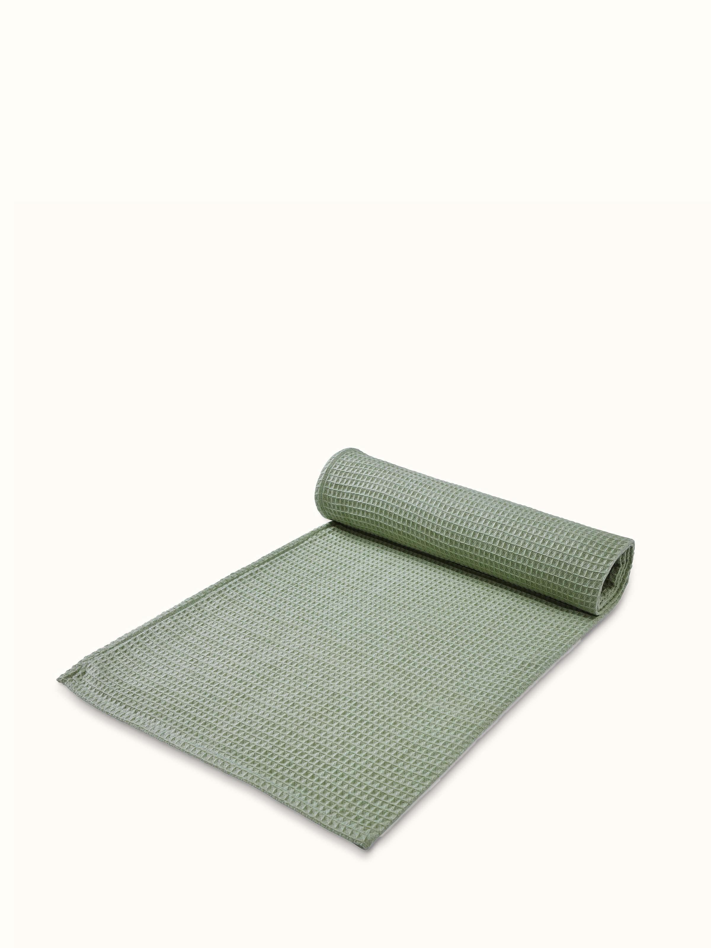 Detailed shot of Amala waffle green solid cotton bath towel emphasizing the fabric's absorbent waffle weave