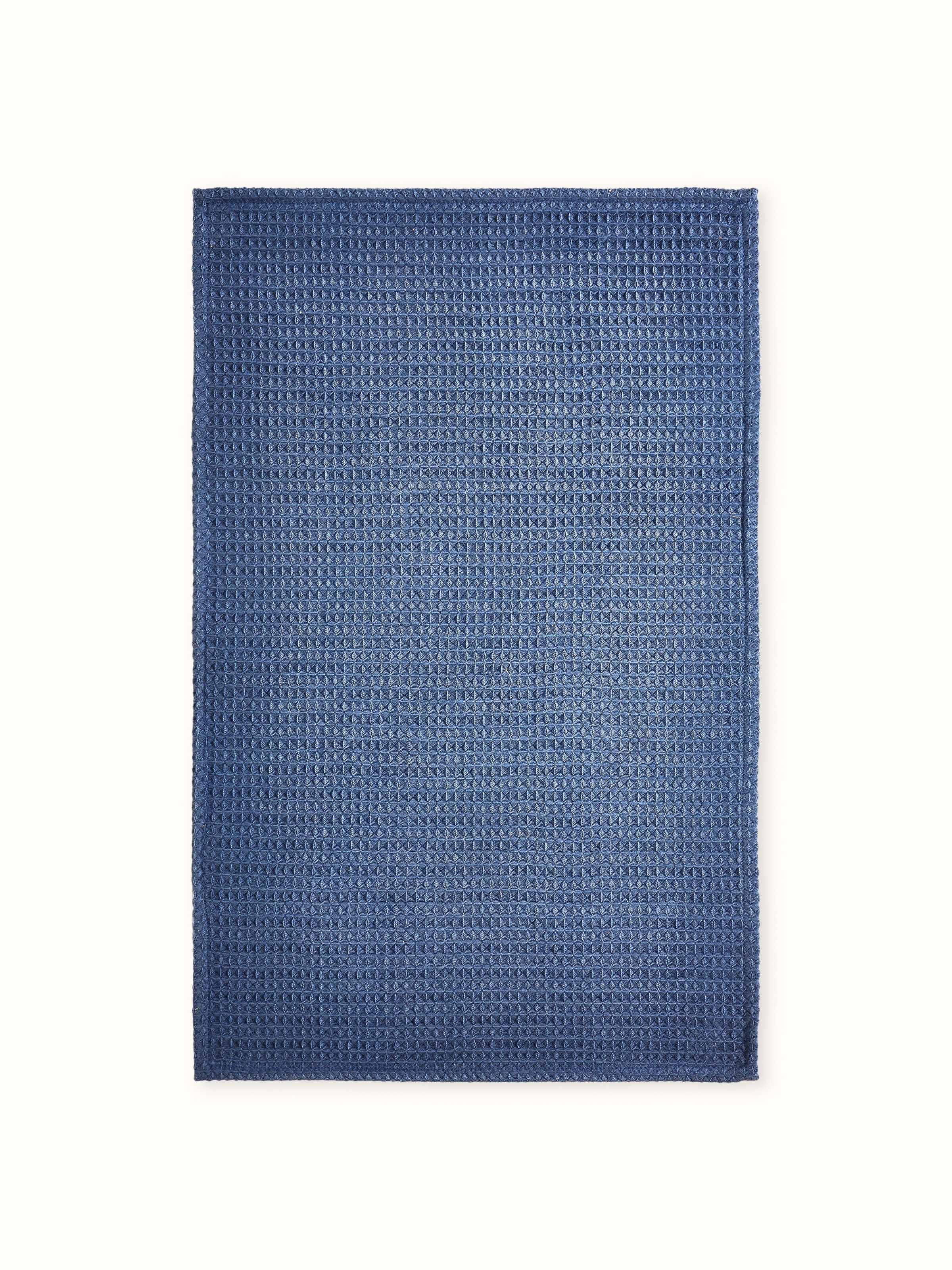 Amala blue waffle cotton hand towels, arranged to show the texture and color in a natural setting.