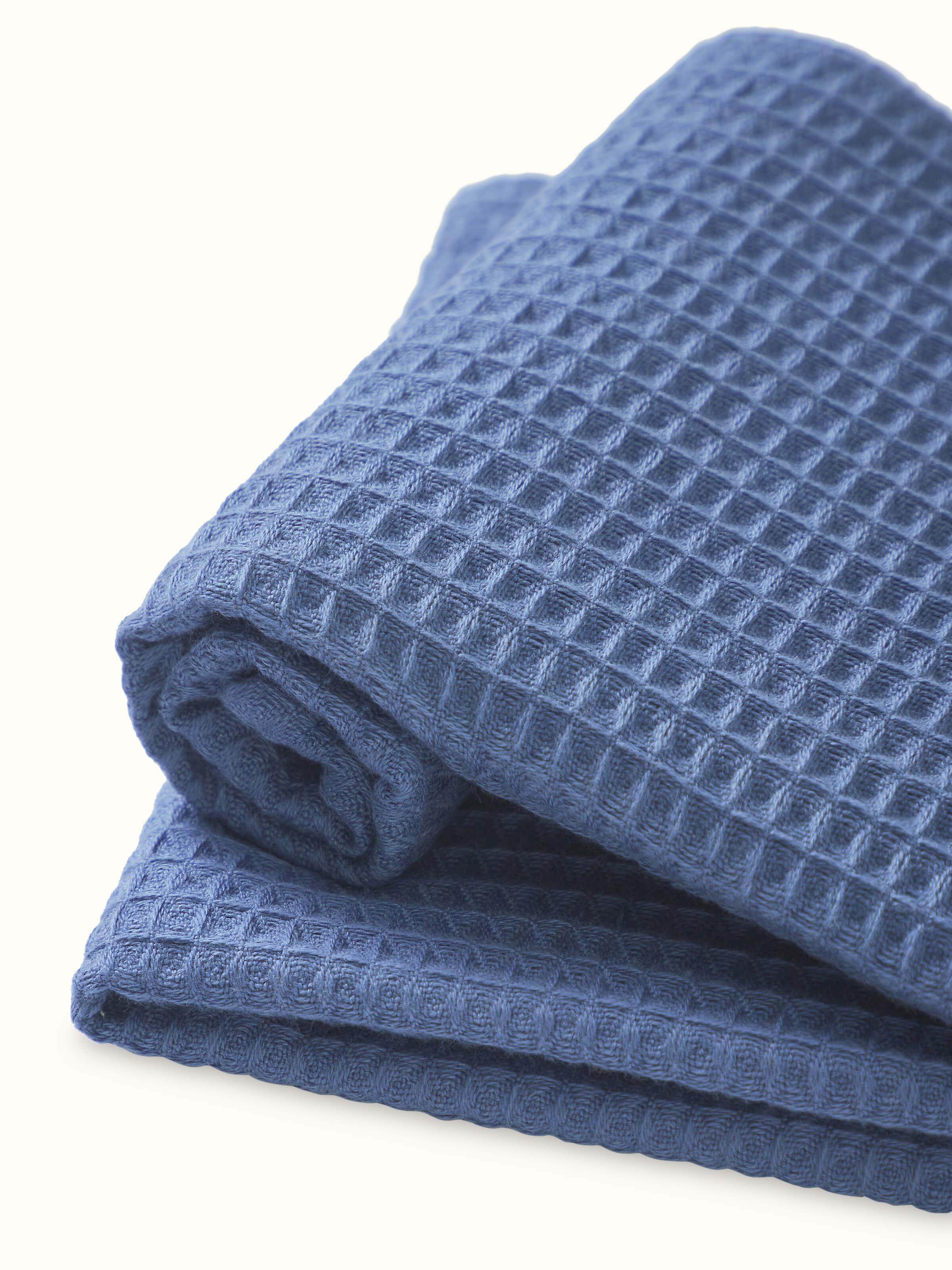 Full view of Amala blue solid cotton hand towels, highlighting the waffle weave and solid color design.