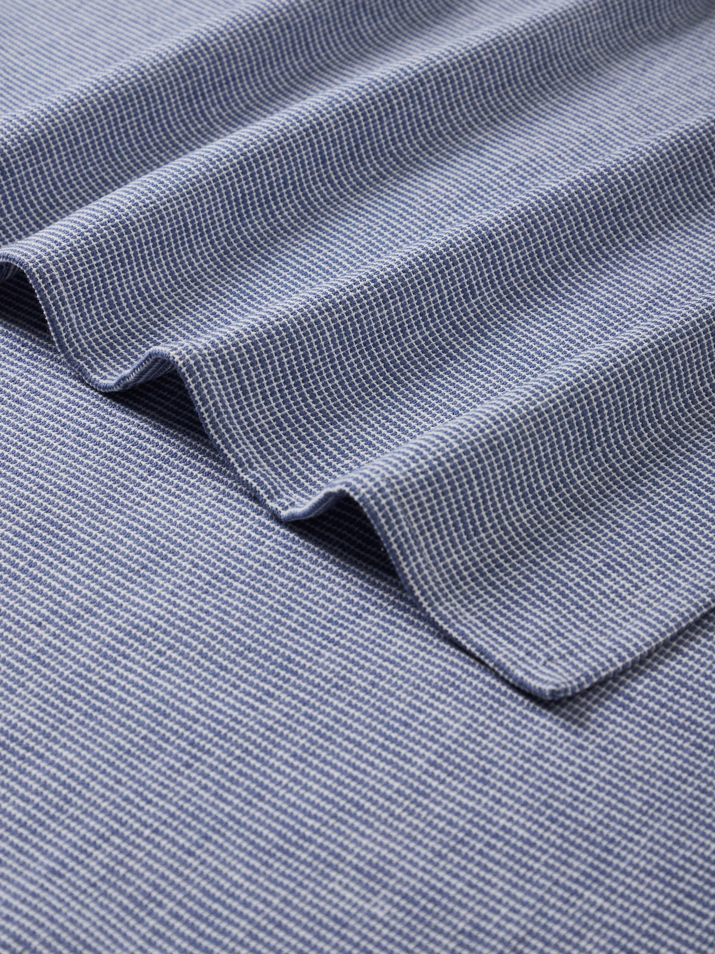 Side view of Shikara blue chambray cotton bath towel displaying its thickness and soft, absorbent material