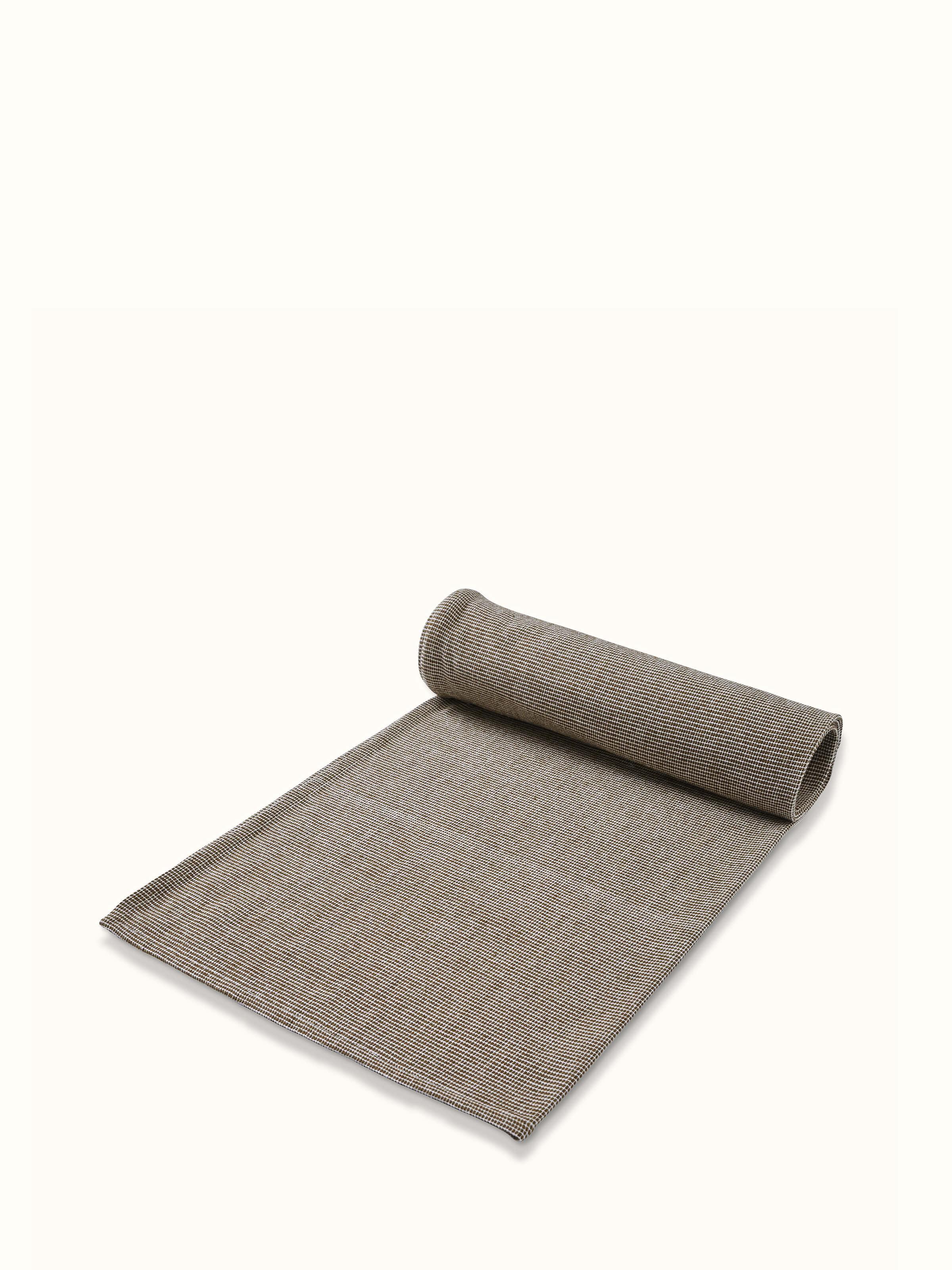 Side view of Shikara green chambray cotton bath towel (M) showing the thickness and edge design
