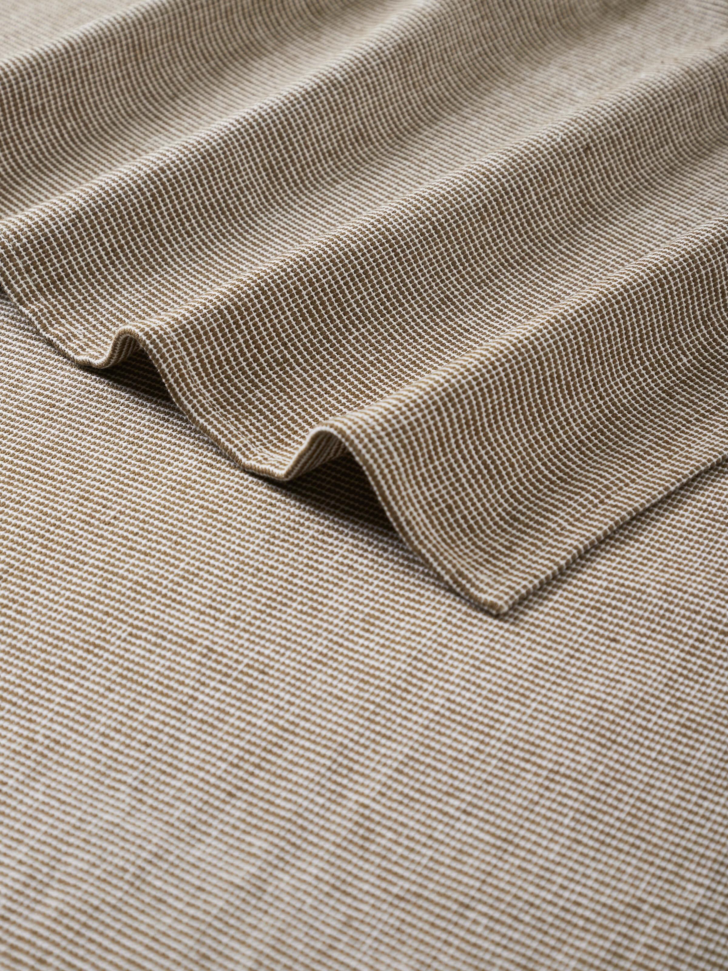 Detailed view of Shikara green chambray cotton bath towel (L) focusing on the fabric texture and color