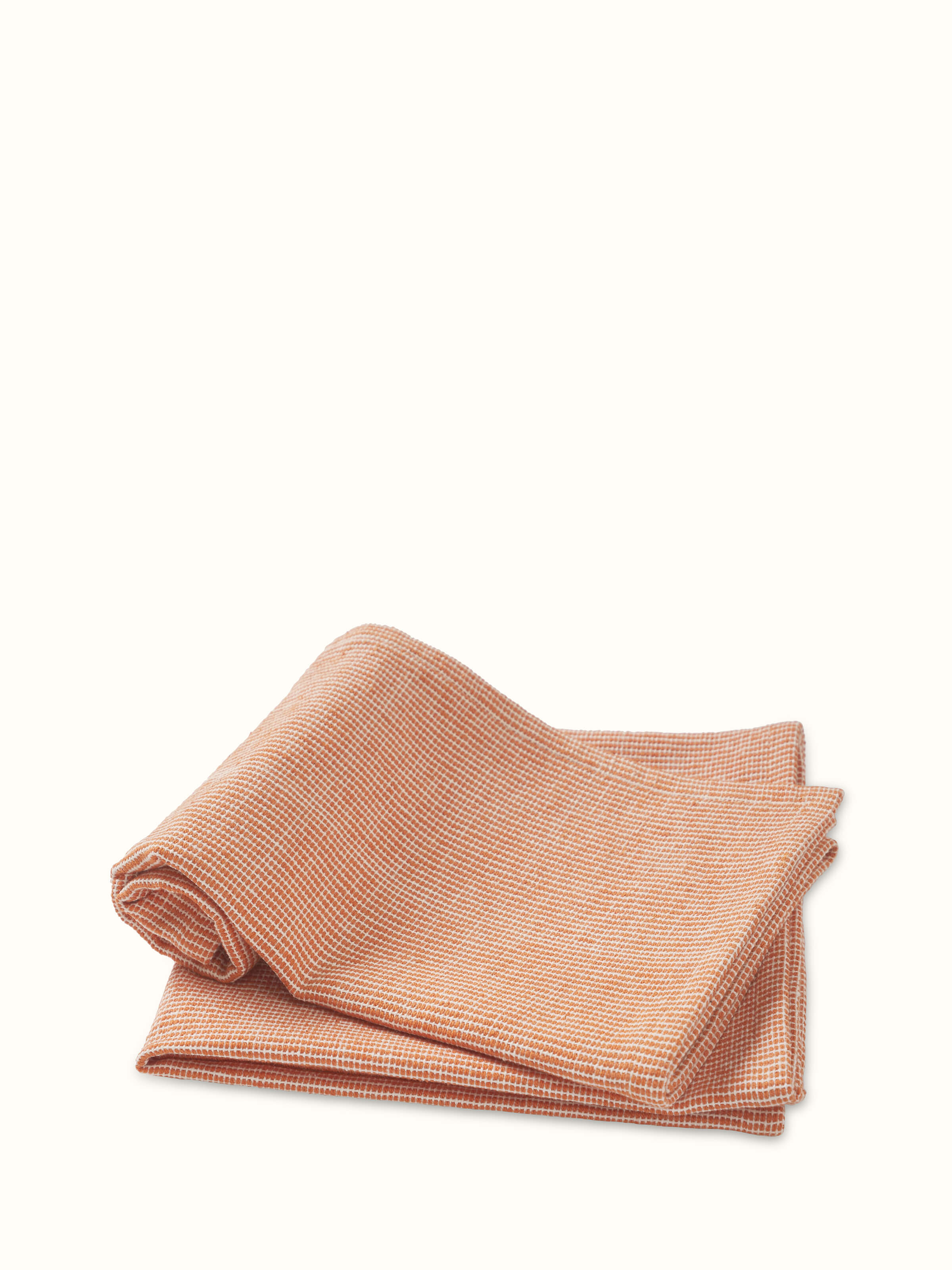 Perspective view of Shikara rust chambray cotton hand towels (2 pcs) displaying the full design and rust color of the towels.