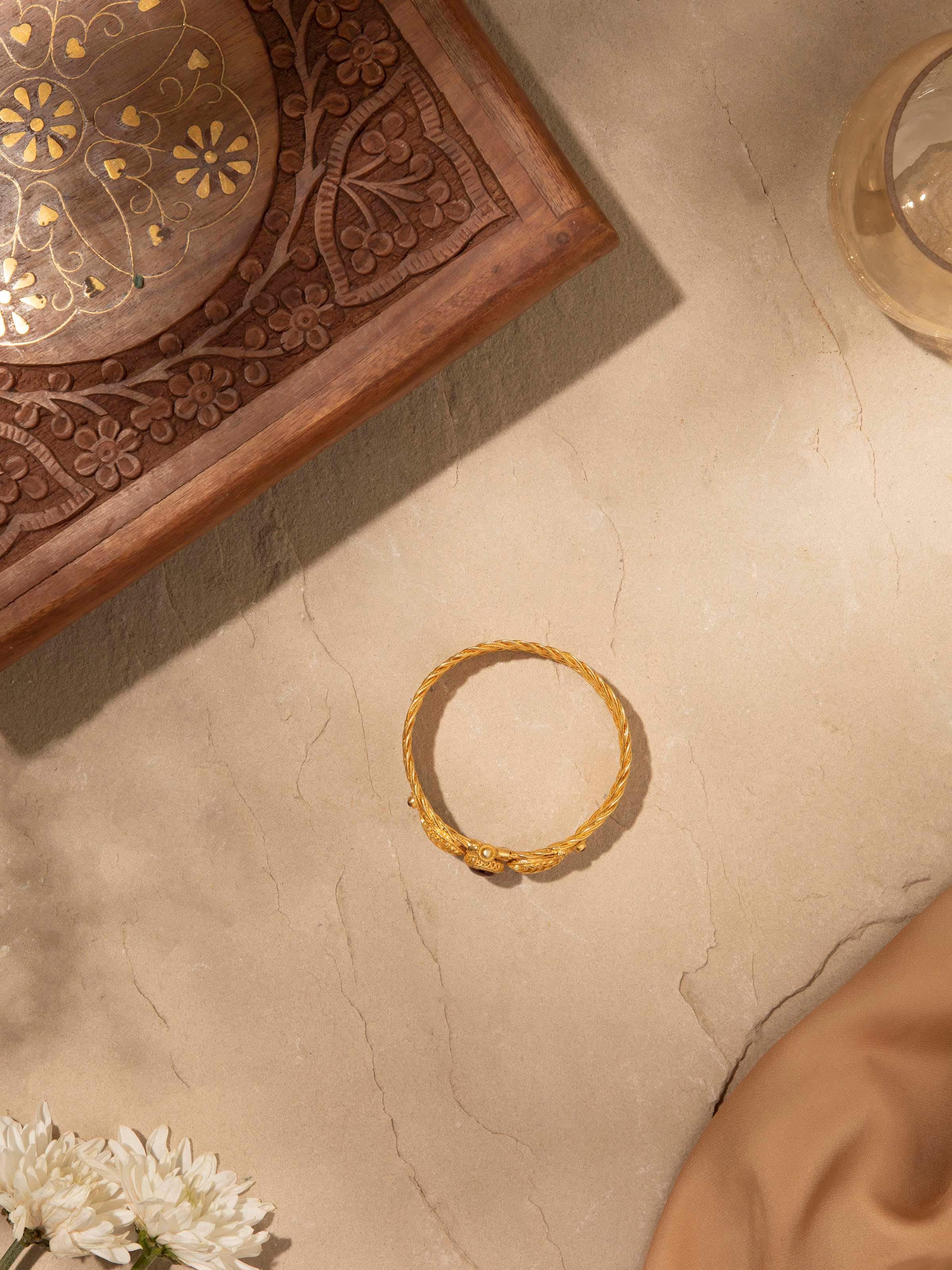 Angled view of Silver Bangle showcasing elegant curves and design details.