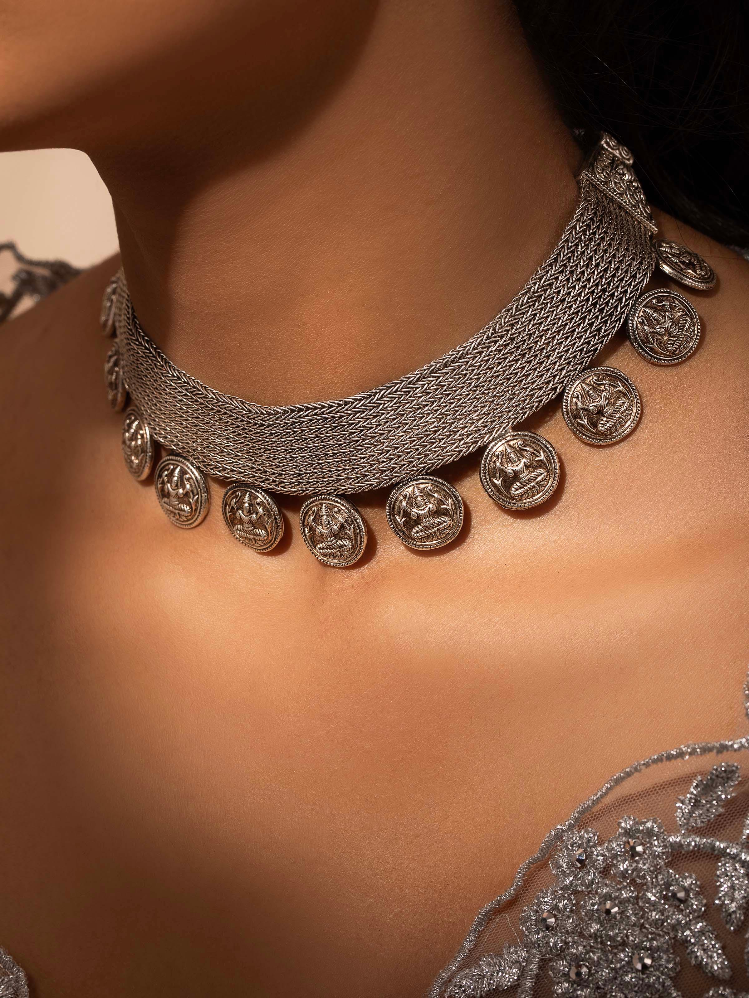 Close-up of Silver collar necklace showing detailed craftsmanship and sleek design elements