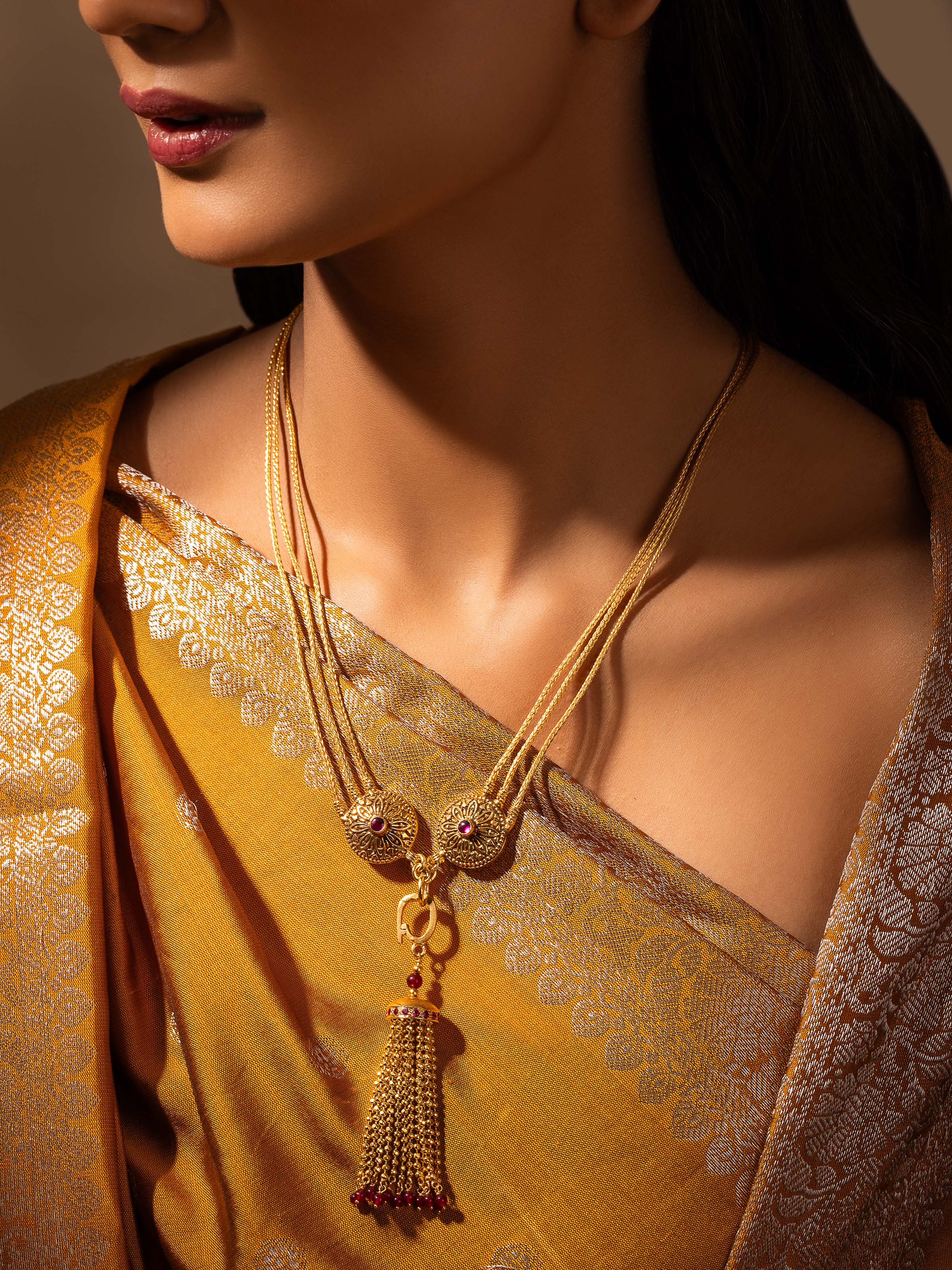 Side view of silver long necklace highlighting its detailed craftsmanship and elegant finish