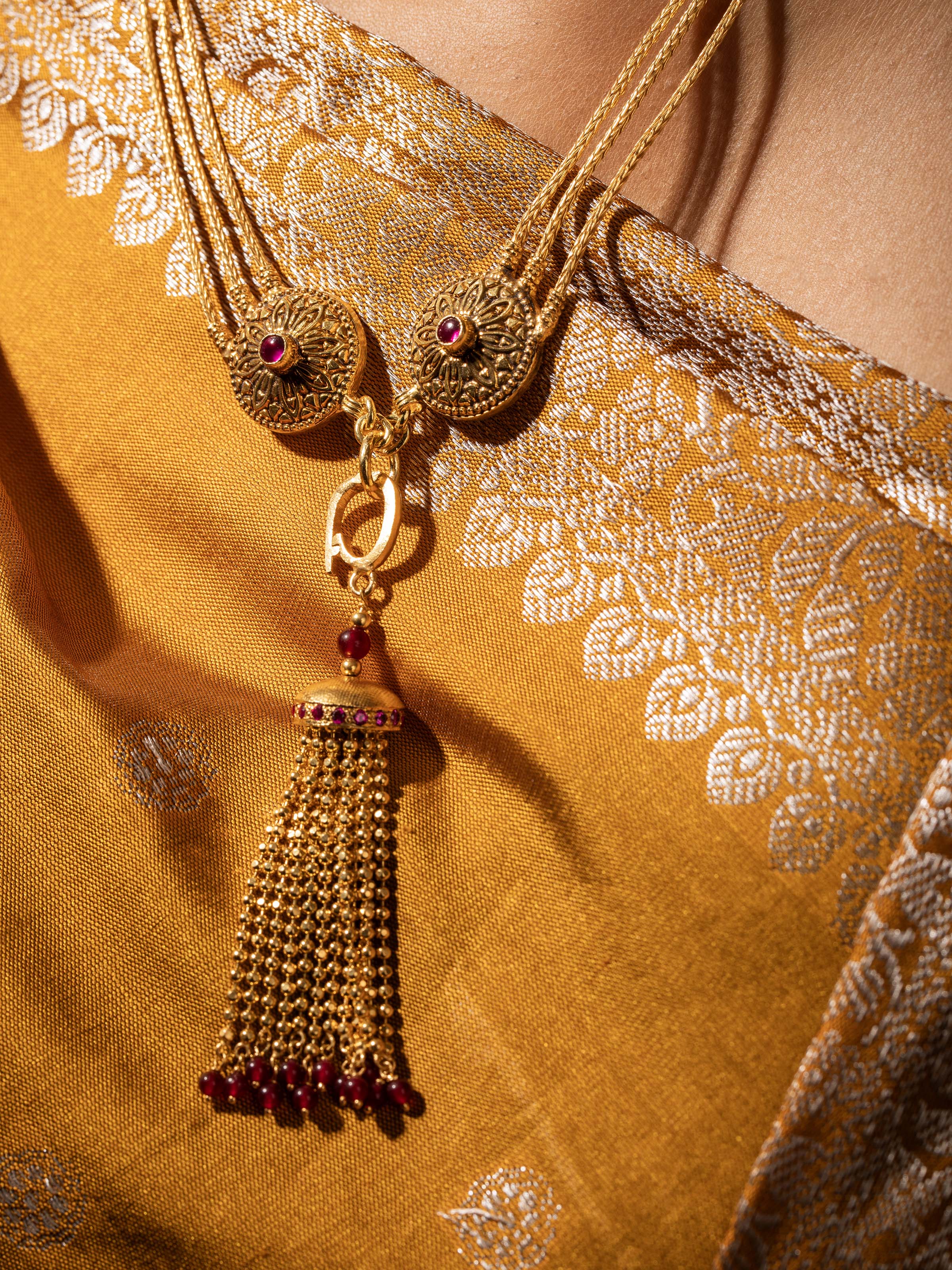 Close-up view of silver long necklace focusing on intricate details and fine craftsmanship