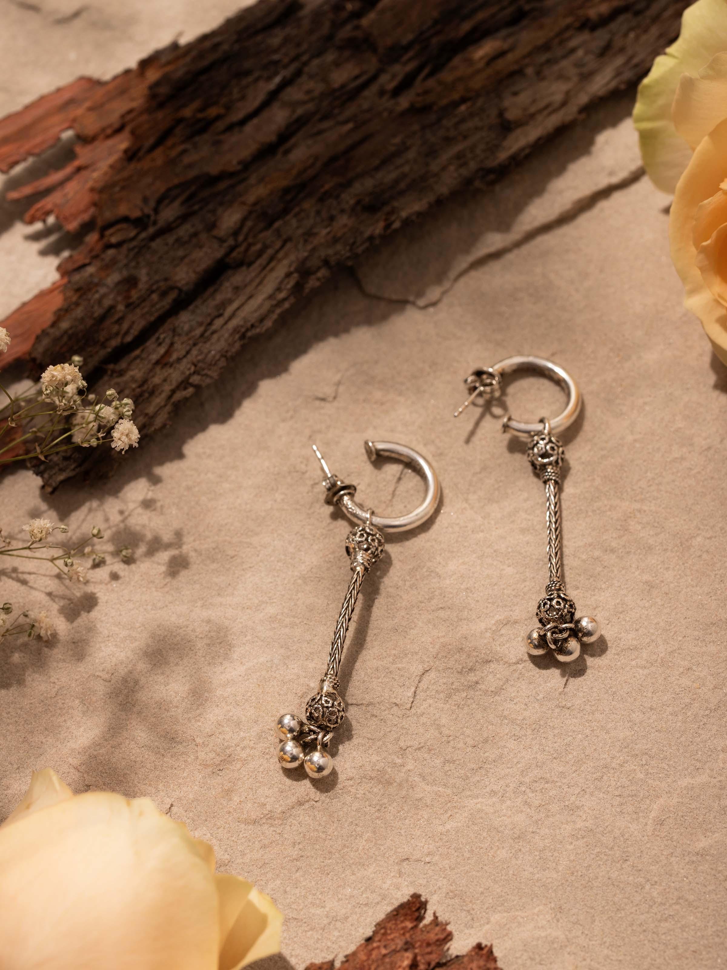 Close-up view of Silver Drop Earrings focusing on the detailed craftsmanship and smooth finish
