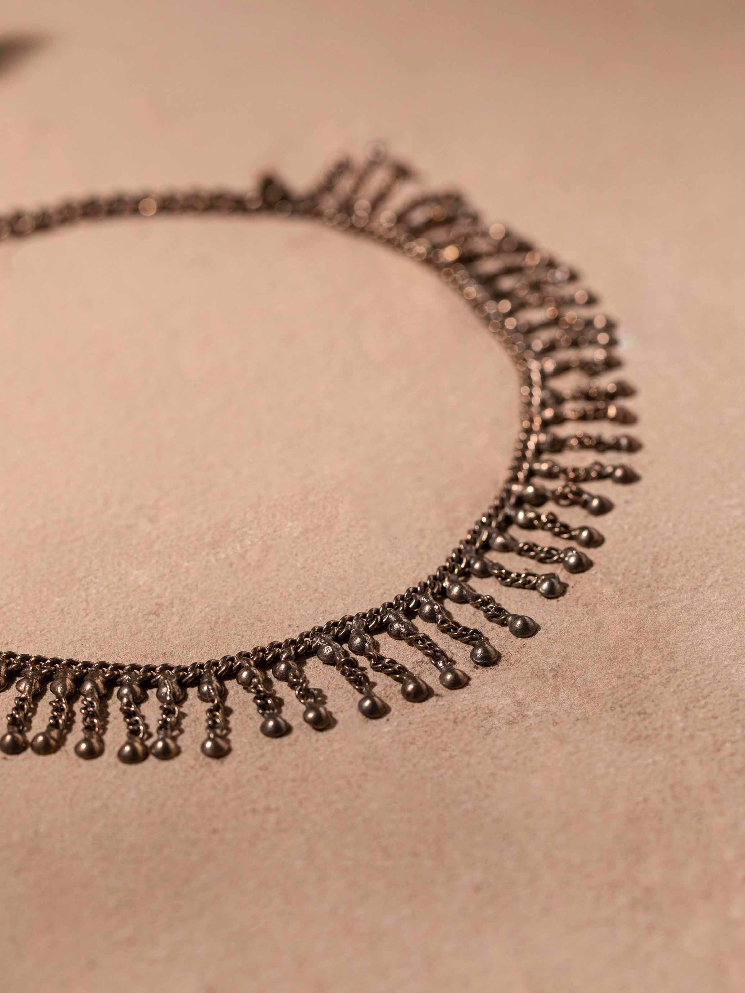 Detailed view of Tribal Silver Collar Necklace by Swadesh focusing on intricate tribal patterns and silver detailing