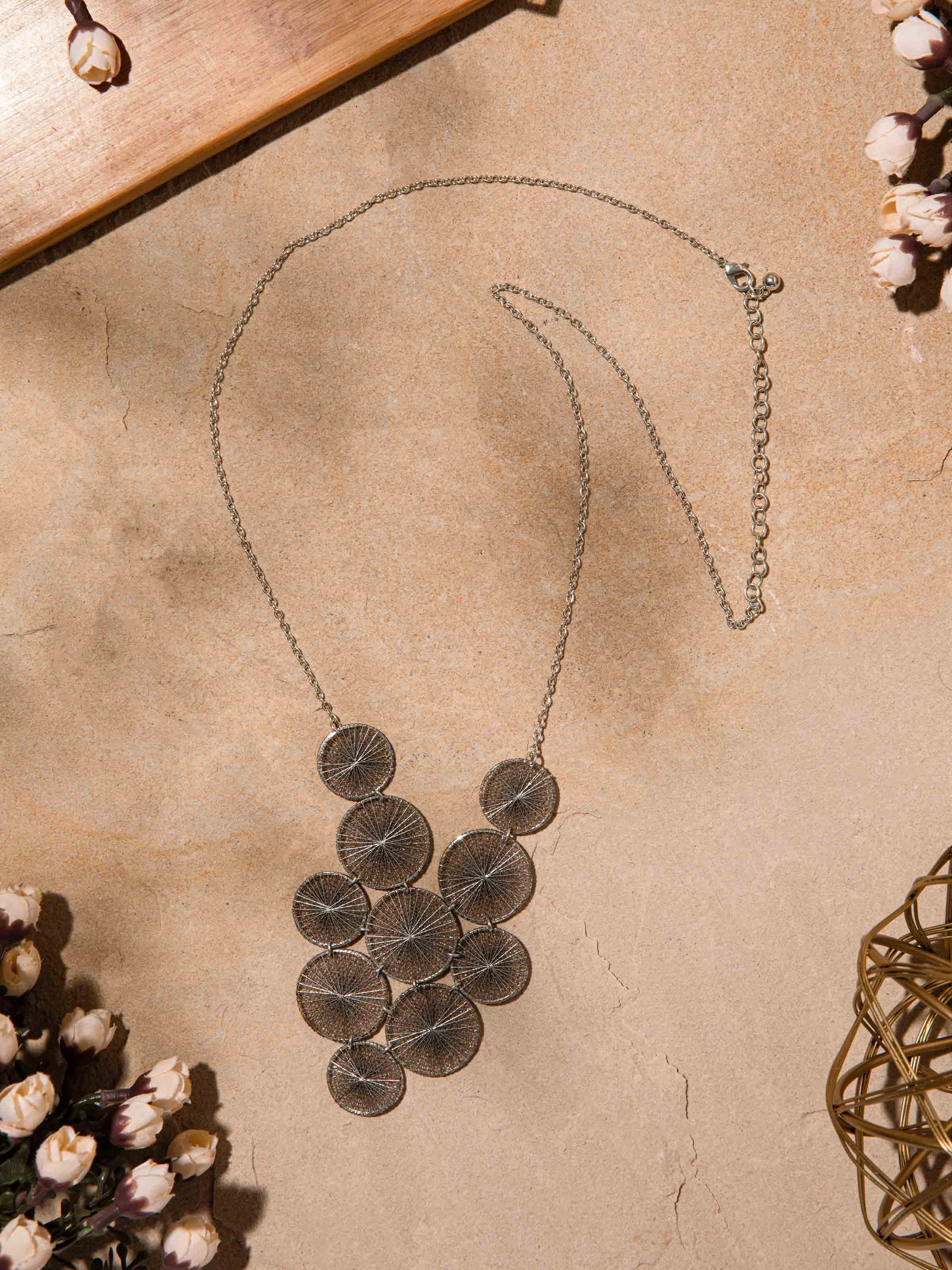 Side view of String Craft Long Necklace illustrating the length and unique string design.